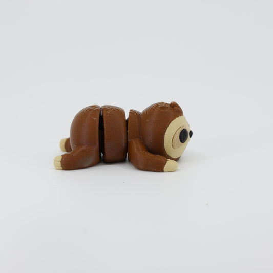 Side profile of the Australian made articulated sloth fidget, showing the relaxed climbing posture and flexi body movement.