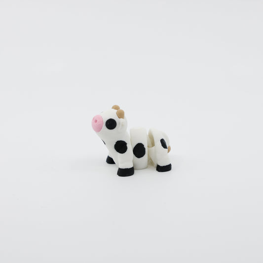 Side profile of articulated cow sensory fidget highlighting body segments and horns