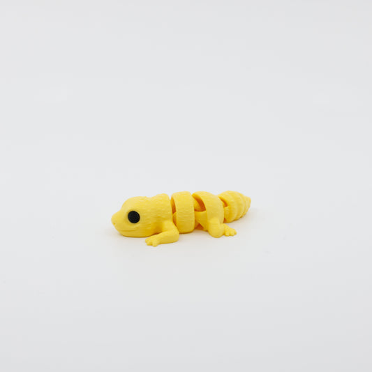 Side profile of articulated gecko sensory fidget with flexible body segments and curved posture