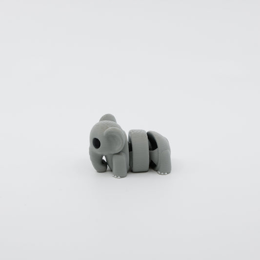 Side profile of articulated elephant sensory fidget highlighting curved body segments and trunk design