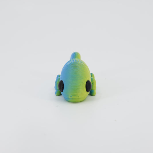 Front view of the Mini Chameleon Wiggle Bud fidget toy. Highlights the crested head and articulated legs created via 3D printing.