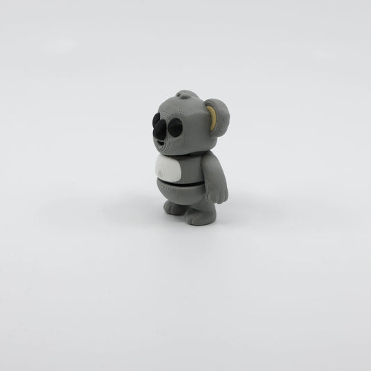 Side profile of articulated koala sensory fidget highlighting body segments and cute pose