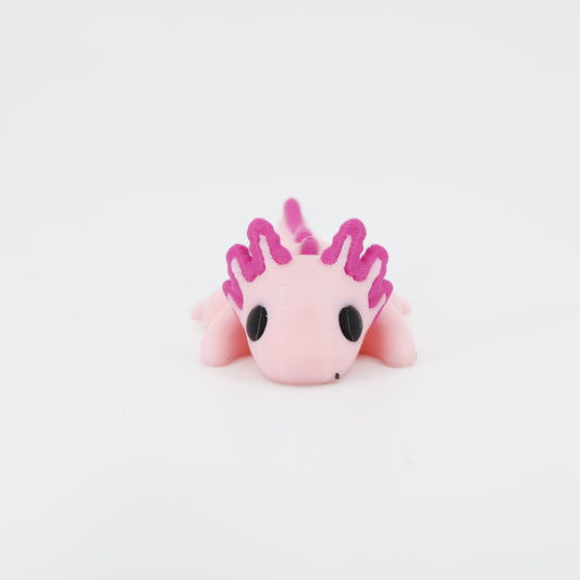 3D printed Axolotl Wiggle Bud flexible toy shown from the front. Highlights the distinct gills and smiling face of the articulated aquatic toy.