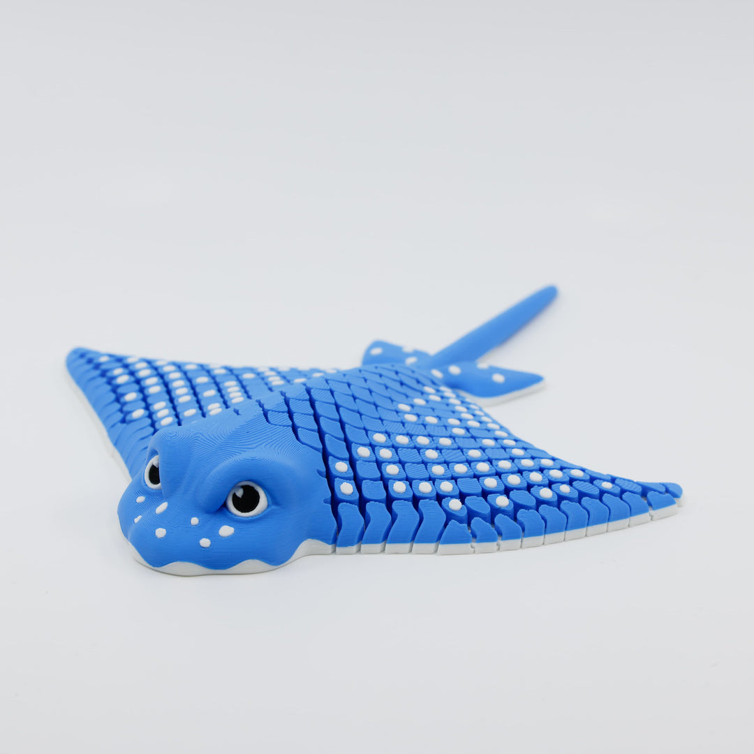 Front view of 3D printed flexible stingray fidget showing detailed facial features and articulated wings in blue