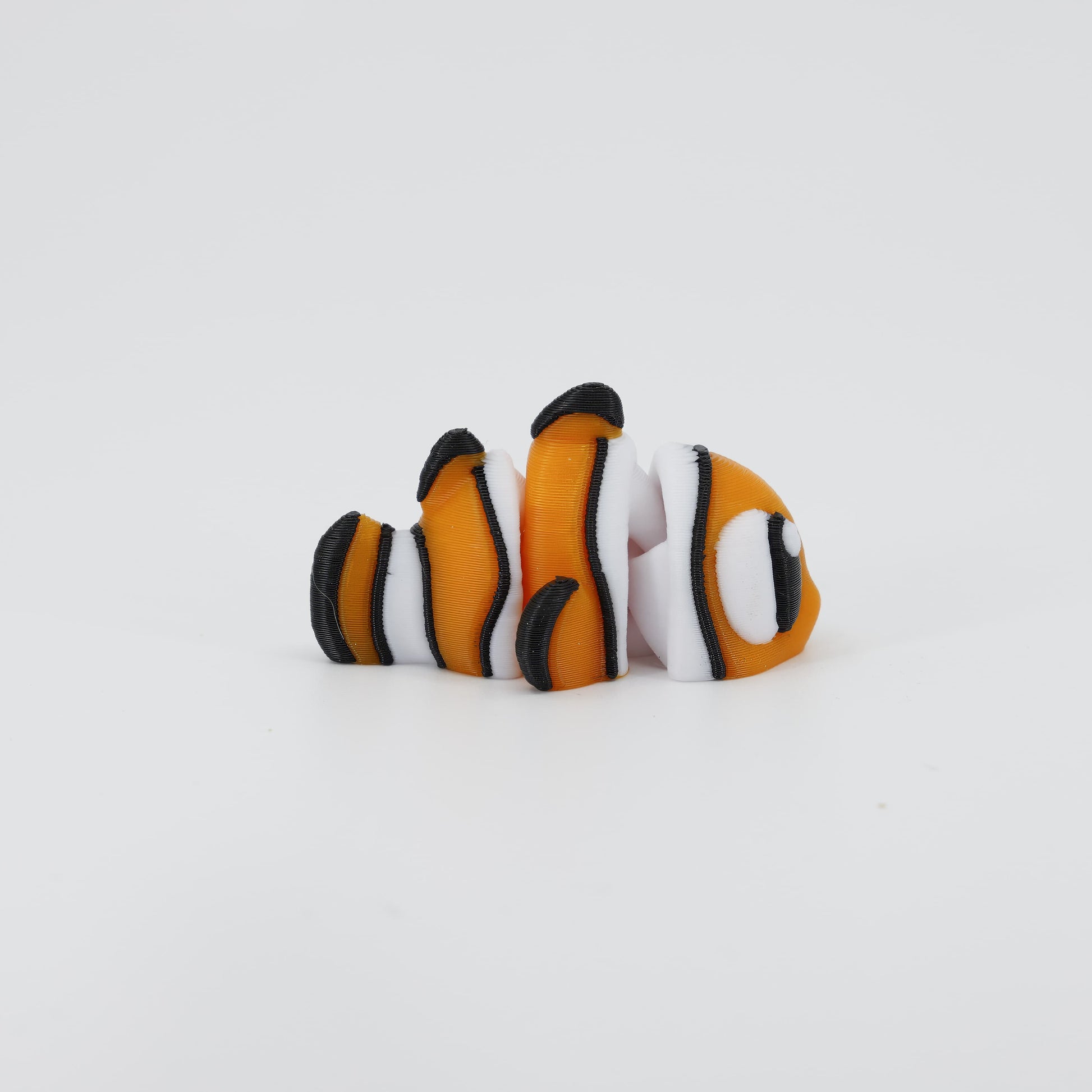 Side view of the Australian made articulated Clownfish Wiggle Bud, emphasizing the stripes and flexi swimming body.