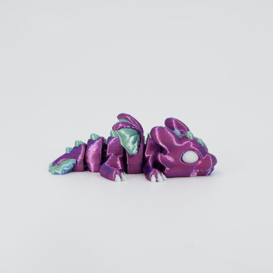 Side profile of the Australian made articulated dragon fidget, showing the flexible spine and mini size perfect for sensory play
