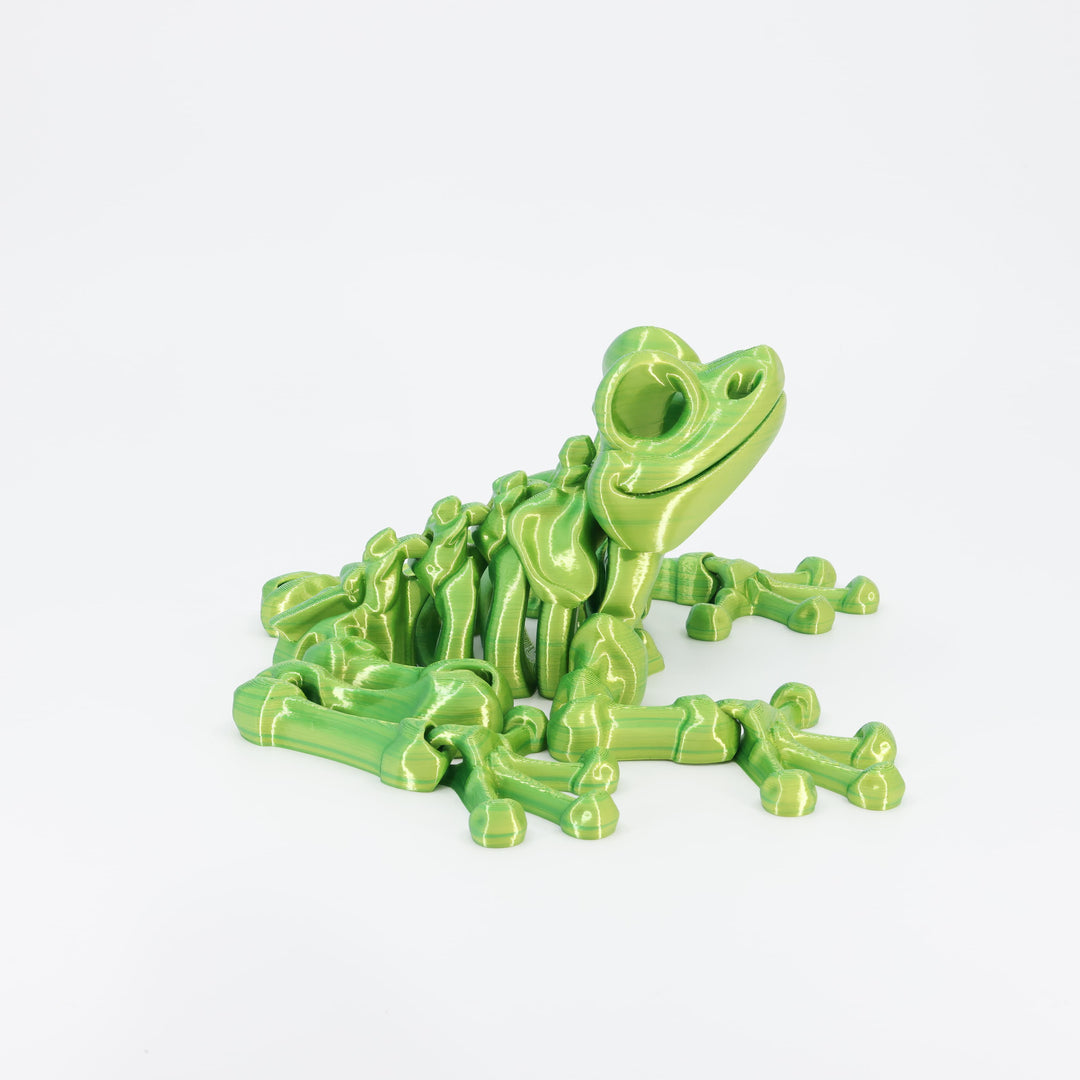 Flexi 3D printed skeleton frog toy shown from the front. Highlights the wide jaw and articulated front legs.