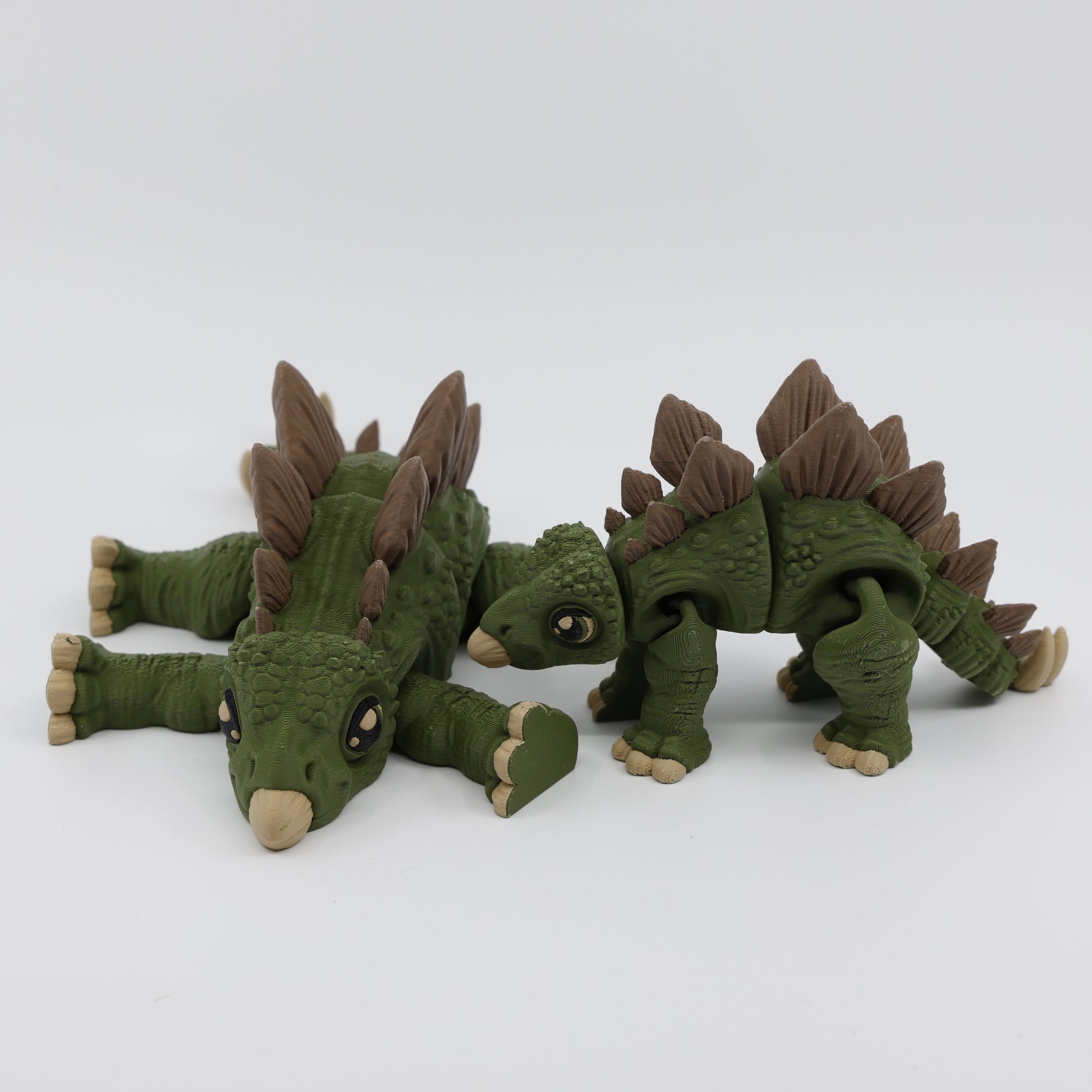 Two Stegosaurus fidgets displayed together – articulated sensory fidget pair