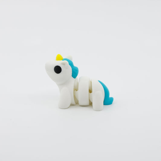 Side profile of articulated unicorn sensory fidget highlighting flowing mane and body segments