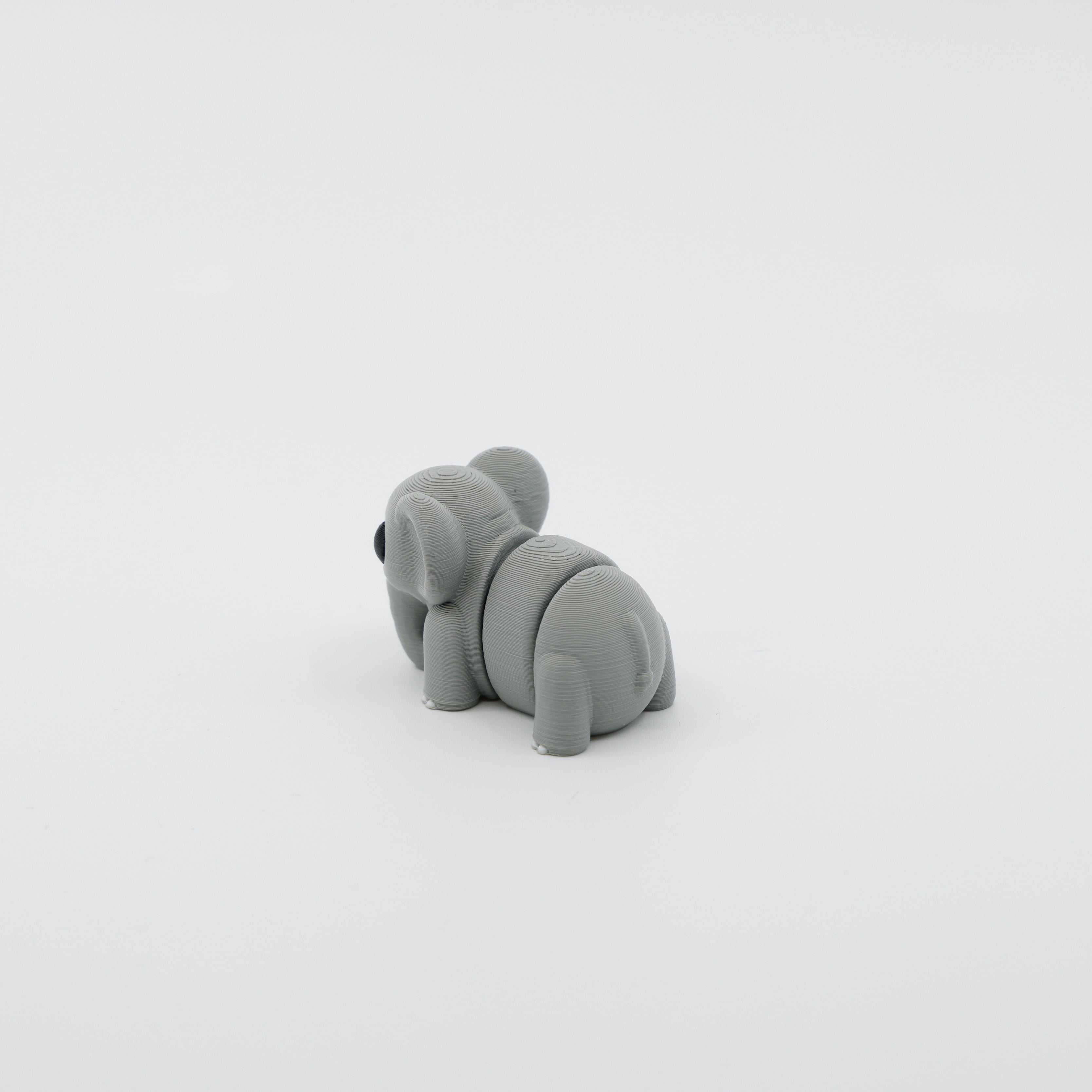 Back view of mini elephant fidget showing segmented articulated body and tail detail