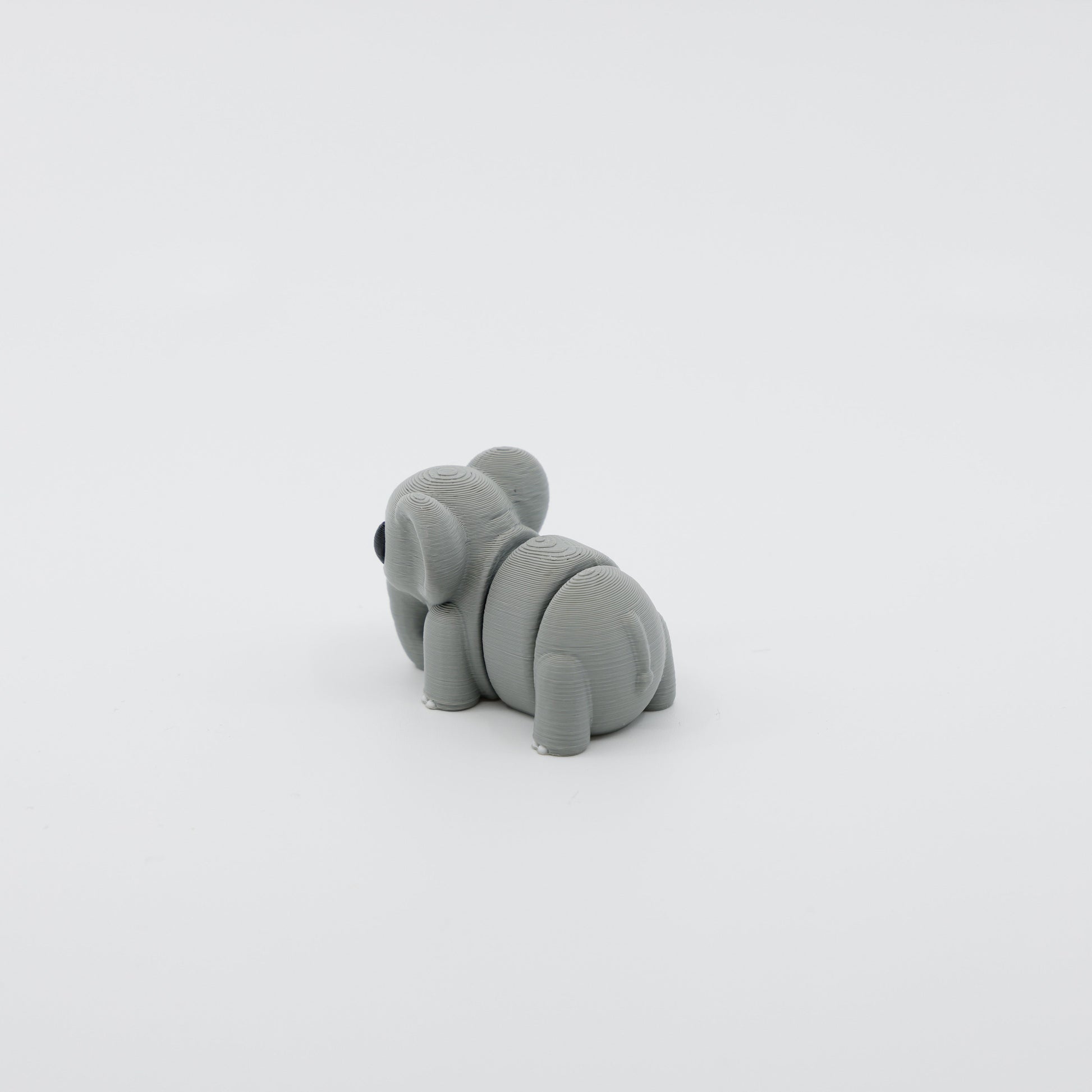 Back view of mini elephant fidget showing segmented articulated body and tail detail