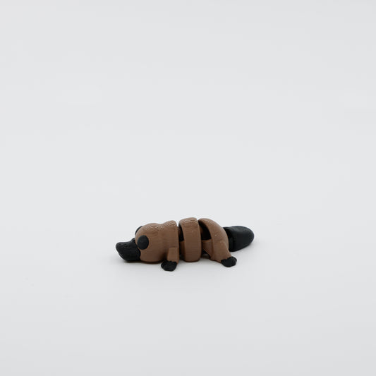Side profile of articulated platypus sensory fidget highlighting body movement and bill shape