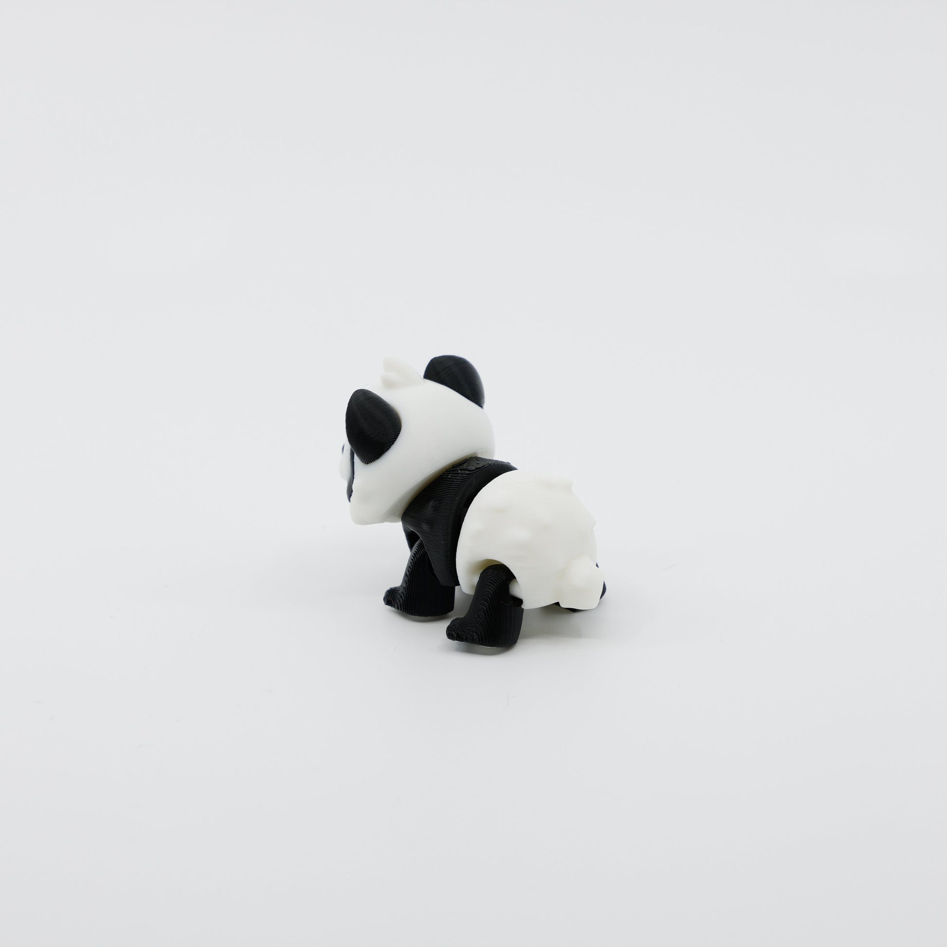 Back view of mini panda fidget showing segmented articulated body and rounded ears
