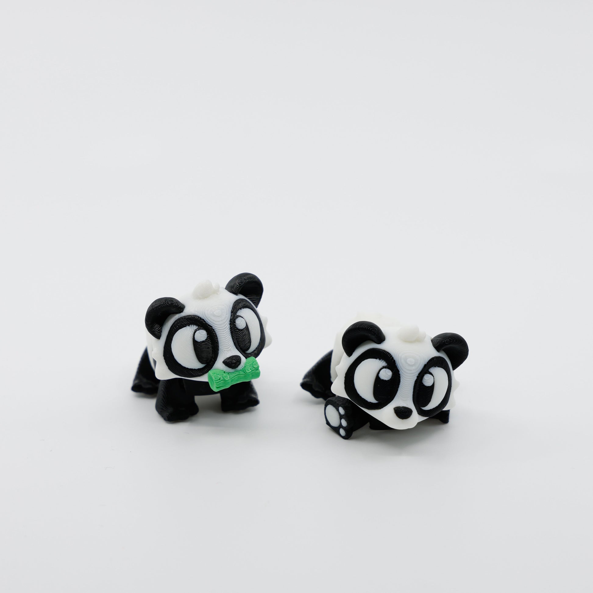 Two articulated panda fidgets side by side, showcasing sensory design and detailed 3D printing