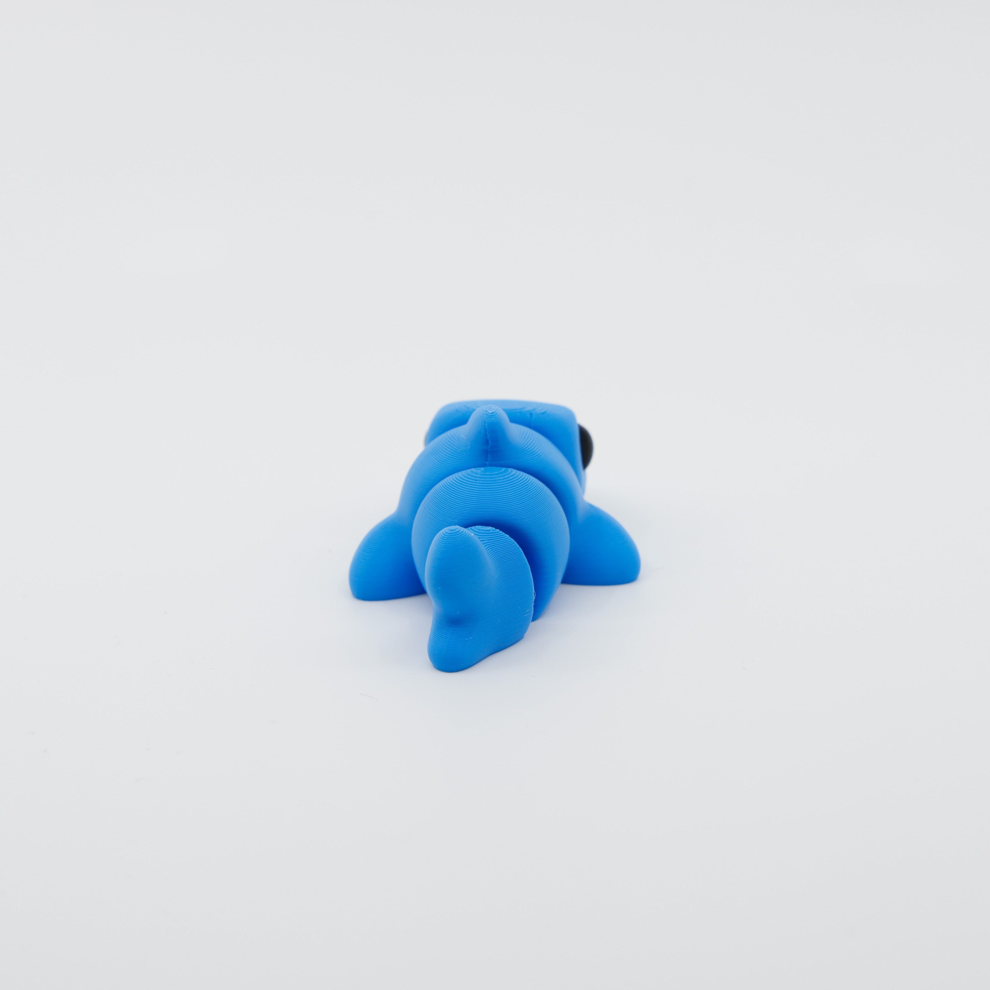 Back view of 3D printed mini shark fidget with segmented articulated body and tail fin detail