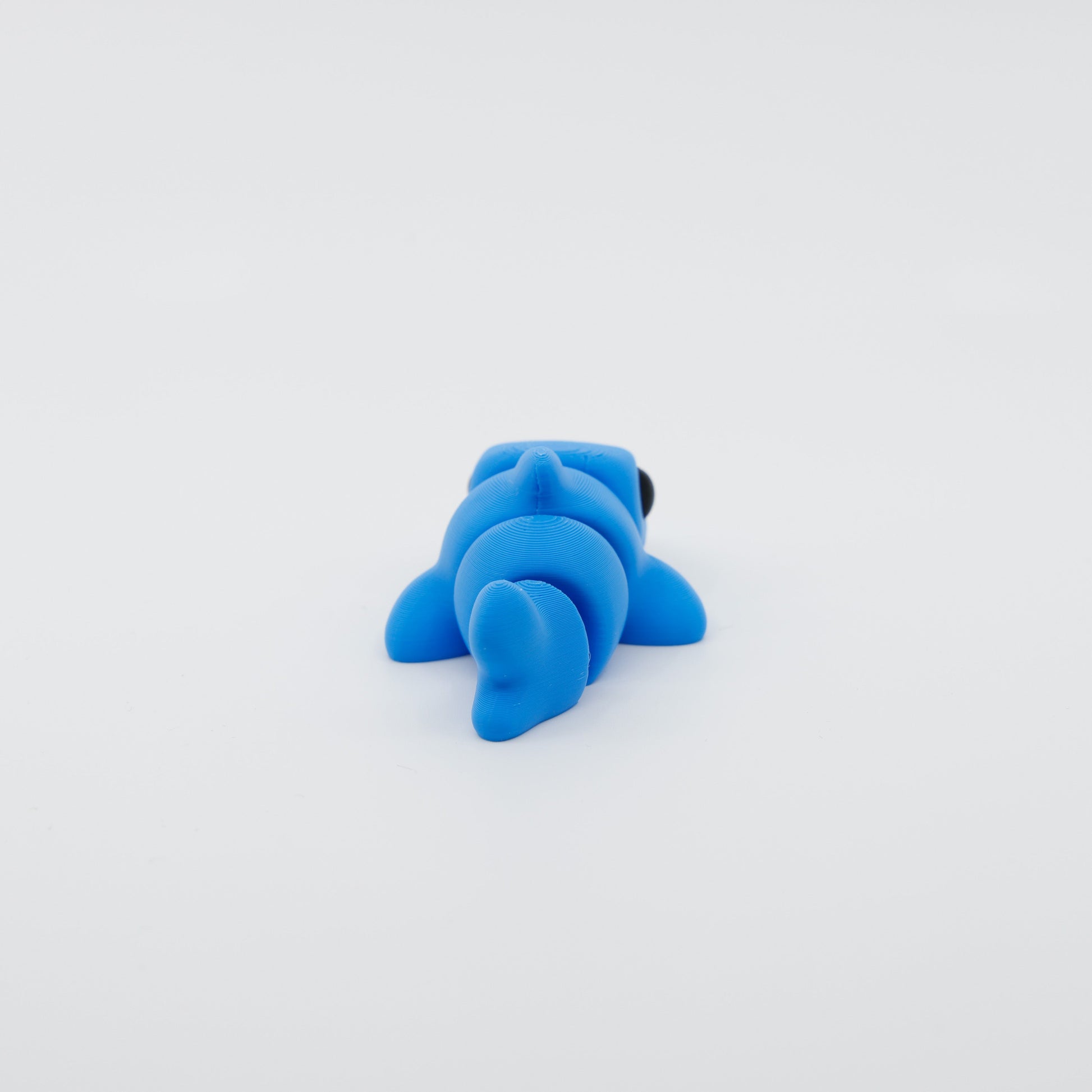 Back view of 3D printed mini shark fidget with segmented articulated body and tail fin detail