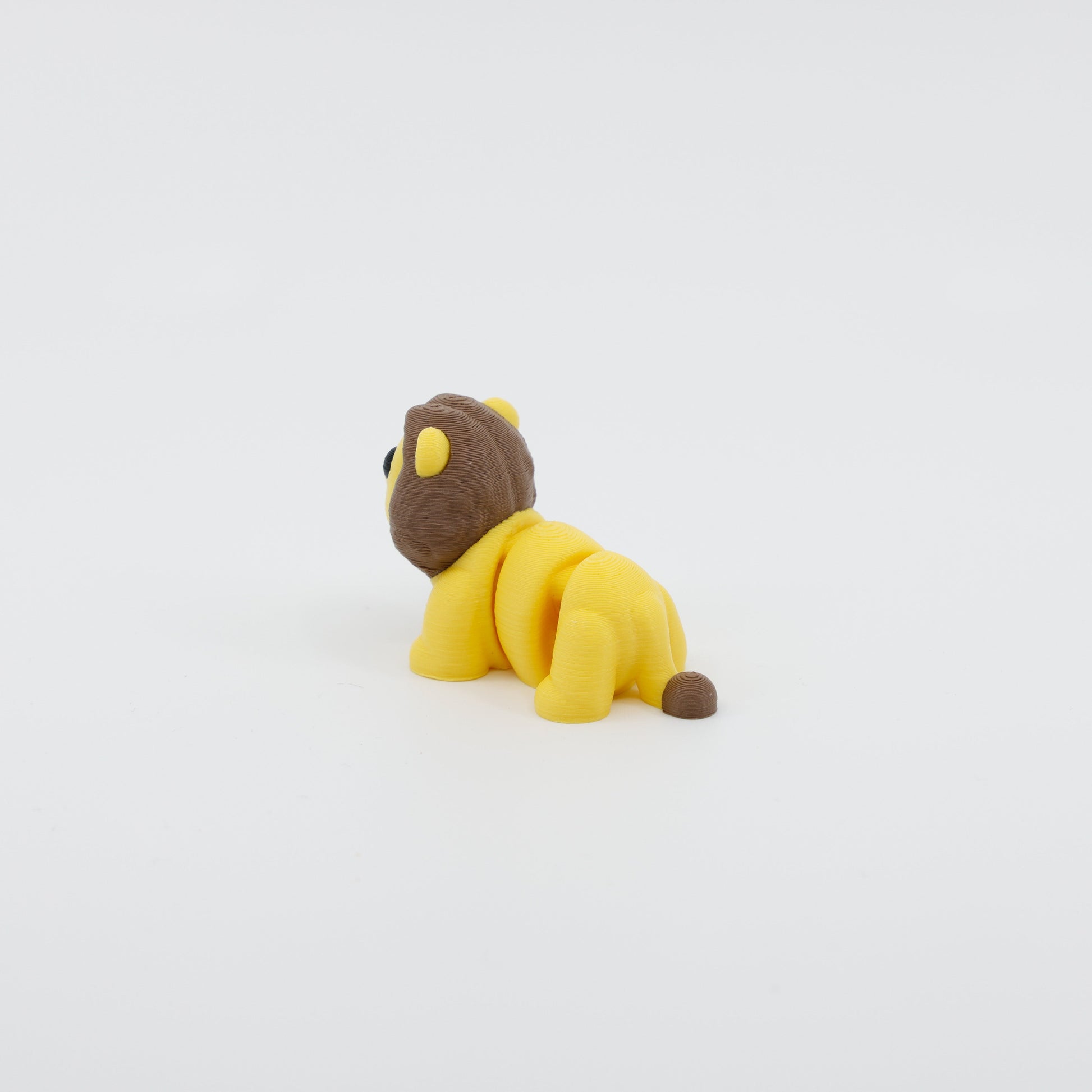 Back view of mini lion fidget showing articulated body segments and detailed tail