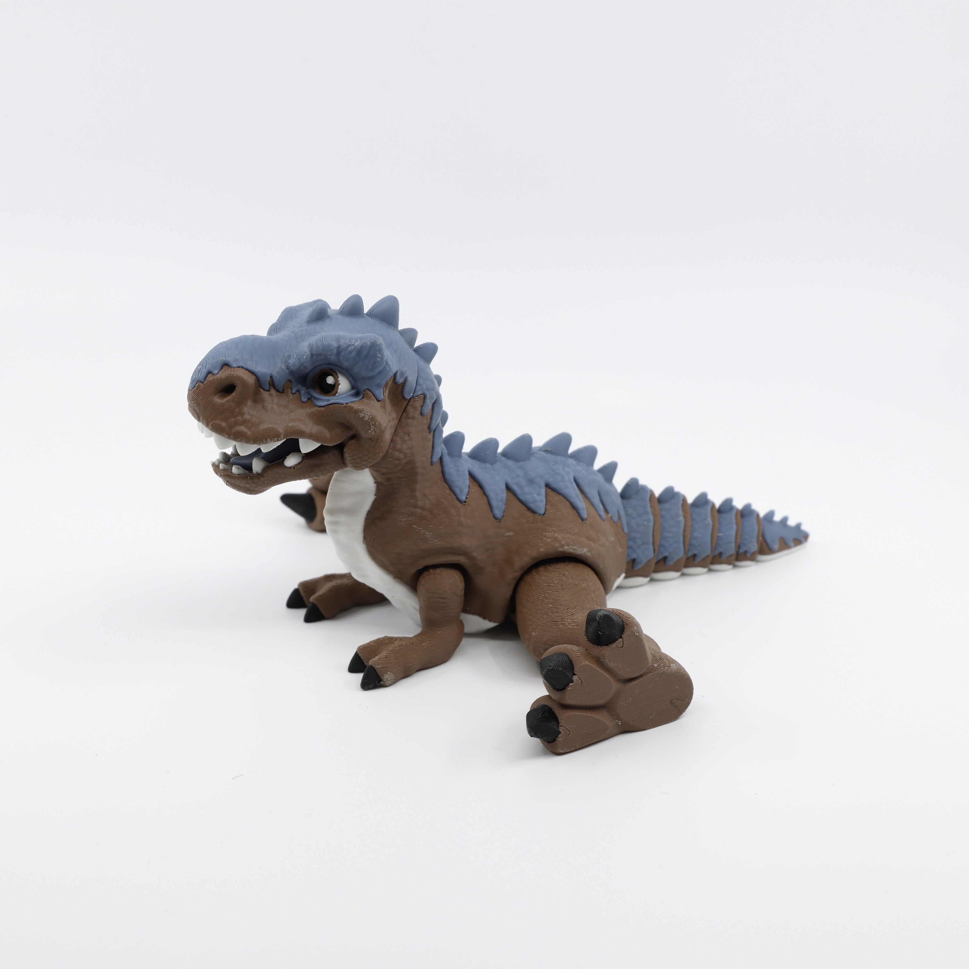 Articulated T-Rex fidget laying down with feet out – sensory dinosaur toy
