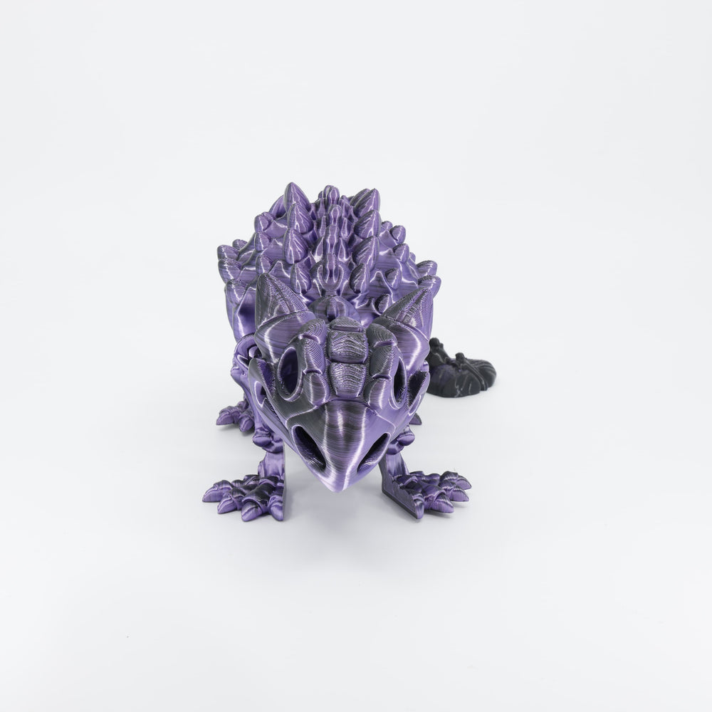 Flexi 3D printed dinosaur skeleton Ankylosaurus shown from the front. Highlights the wide, armoured stance and articulated head.