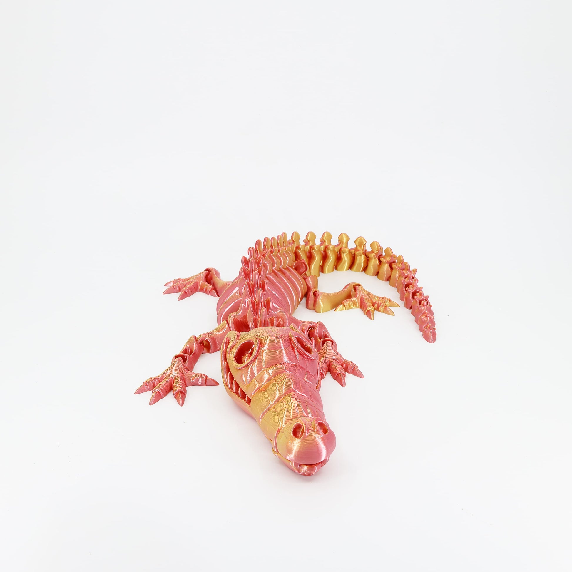 Flexi 3D printed skeleton crocodile toy shown from the front. Highlights the long skeletal snout.