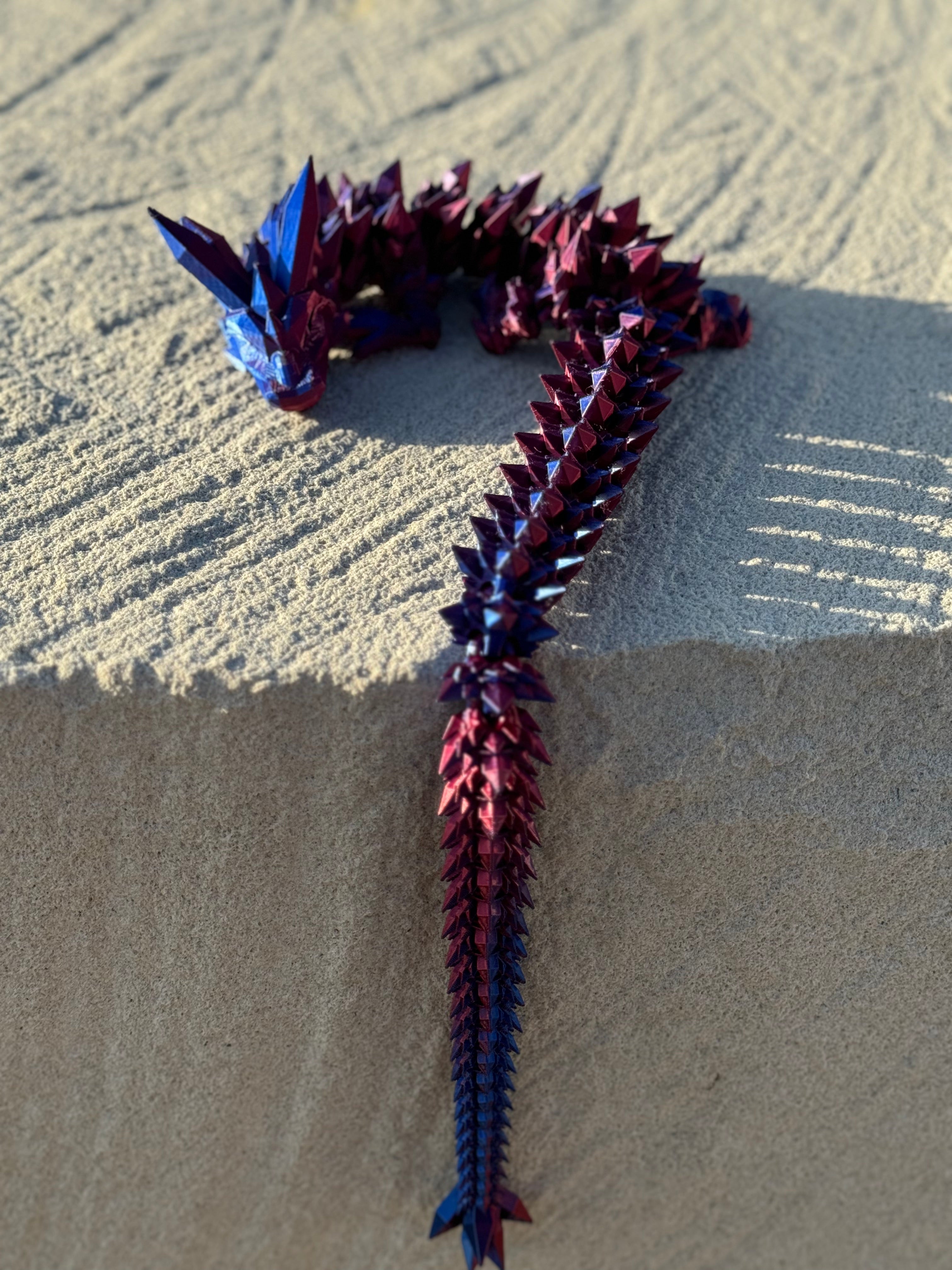 Crystal Dragon with tail hanging off rock ledge