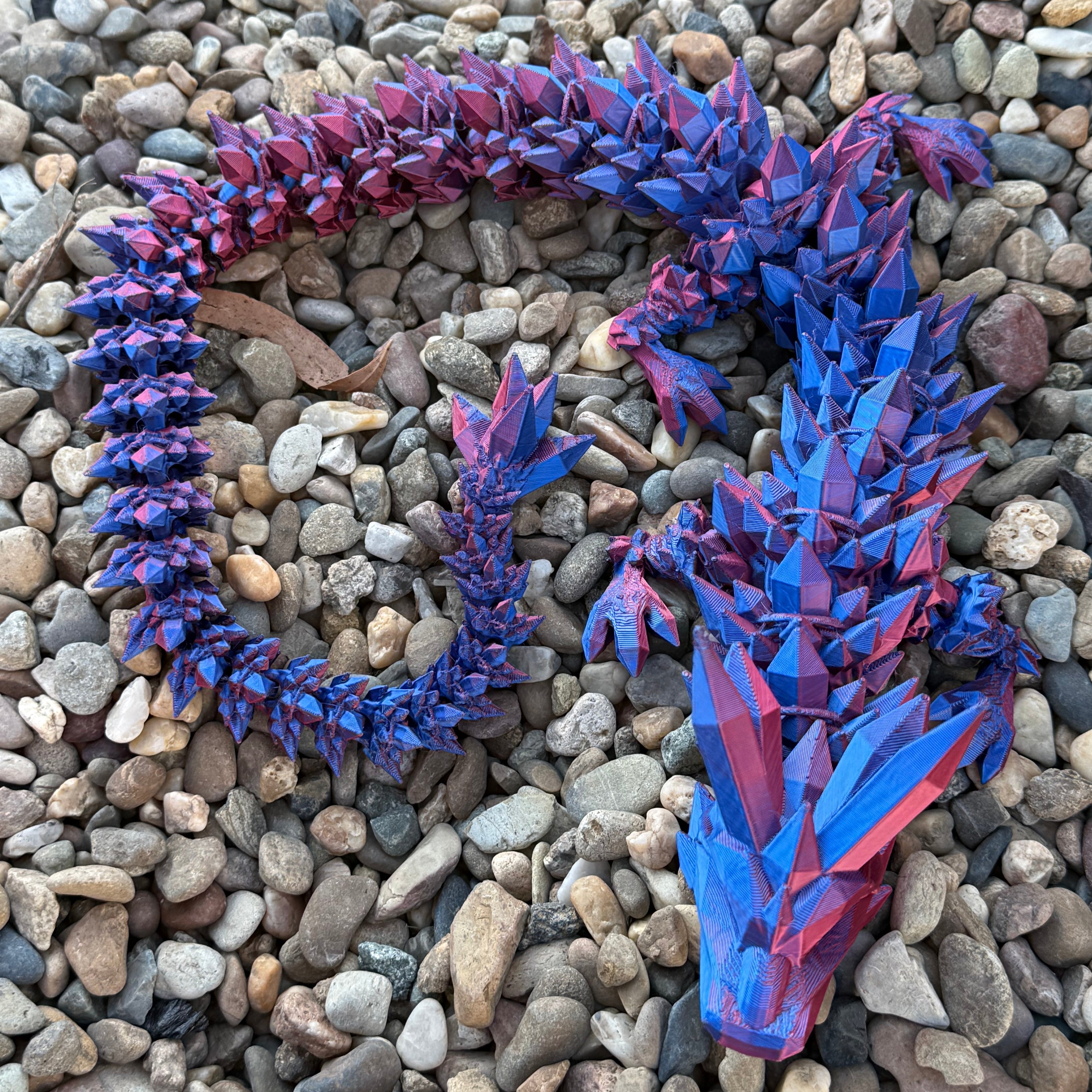 Crystal Dragon Curled onto pebbles