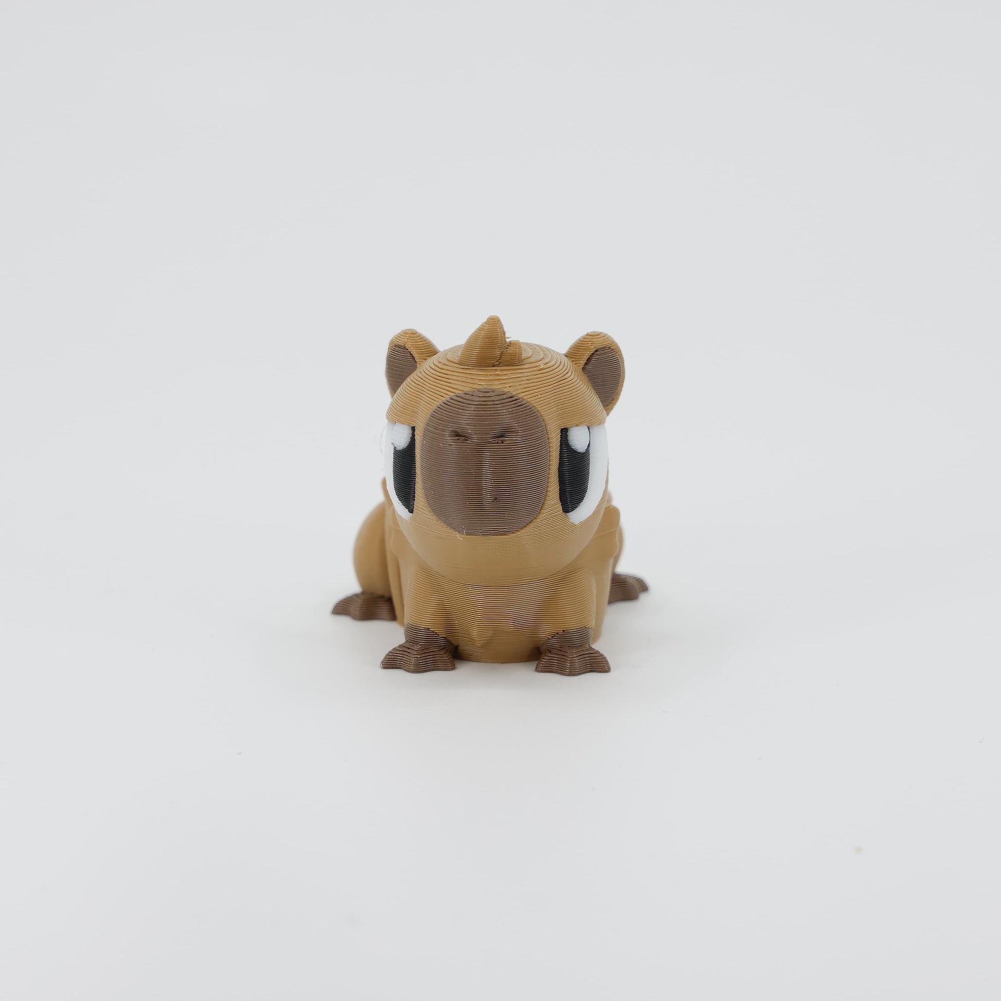 Front view of the Mini Capybara Wiggle Bud fidget toy. Highlights the cute blocky head and articulated paws created via 3D printing.