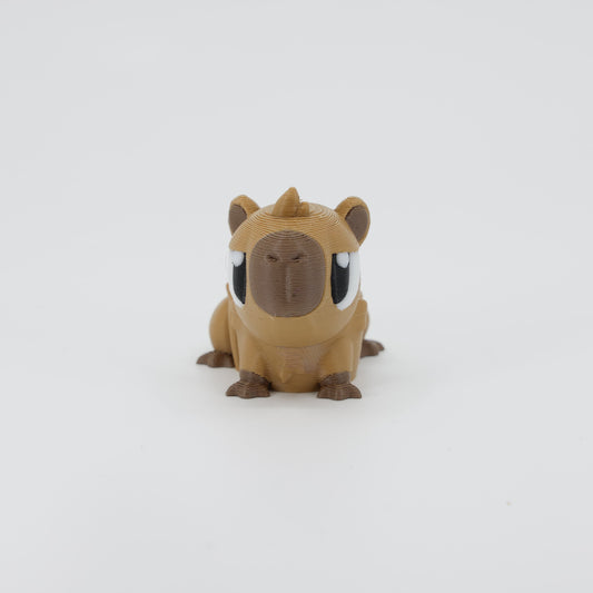 Front view of the Mini Capybara Wiggle Bud fidget toy. Highlights the cute blocky head and articulated paws created via 3D printing.