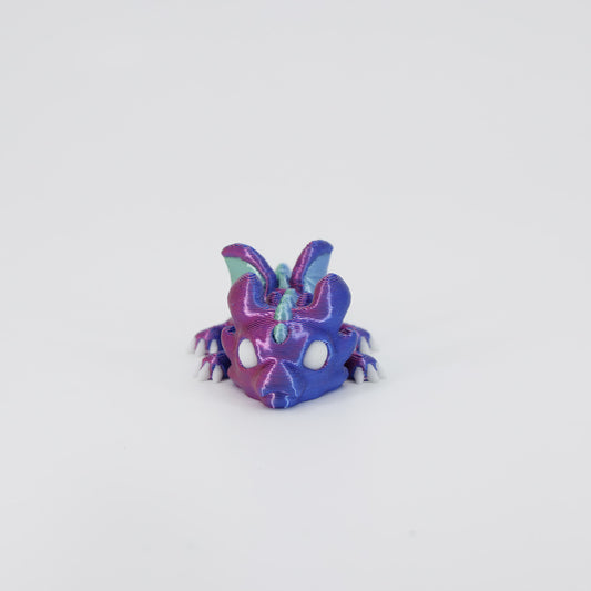Front view of the Mini Dragon Wiggle Bud fidget toy. Highlights the cute face and fully articulated wings created via 3D printing