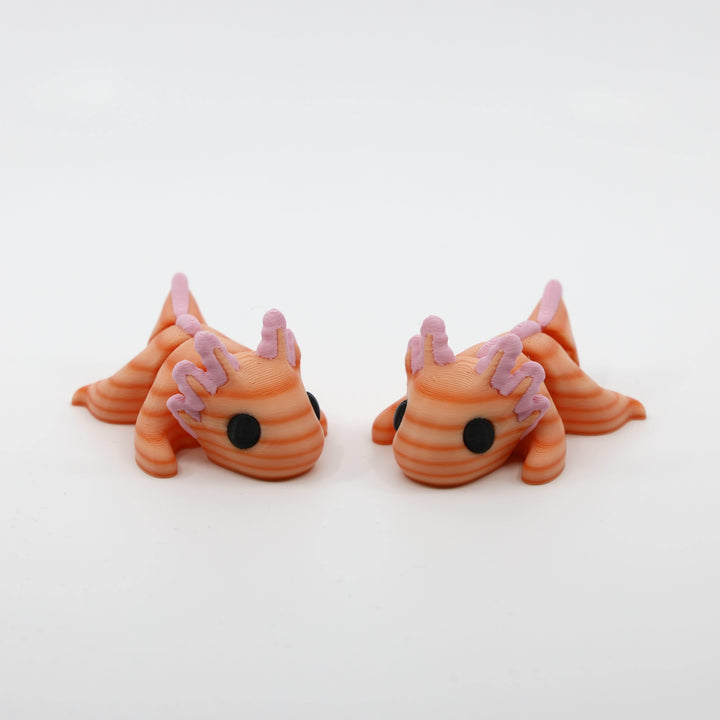 Two Mini Axolotl Fidgets posed together as sensory fidget companions