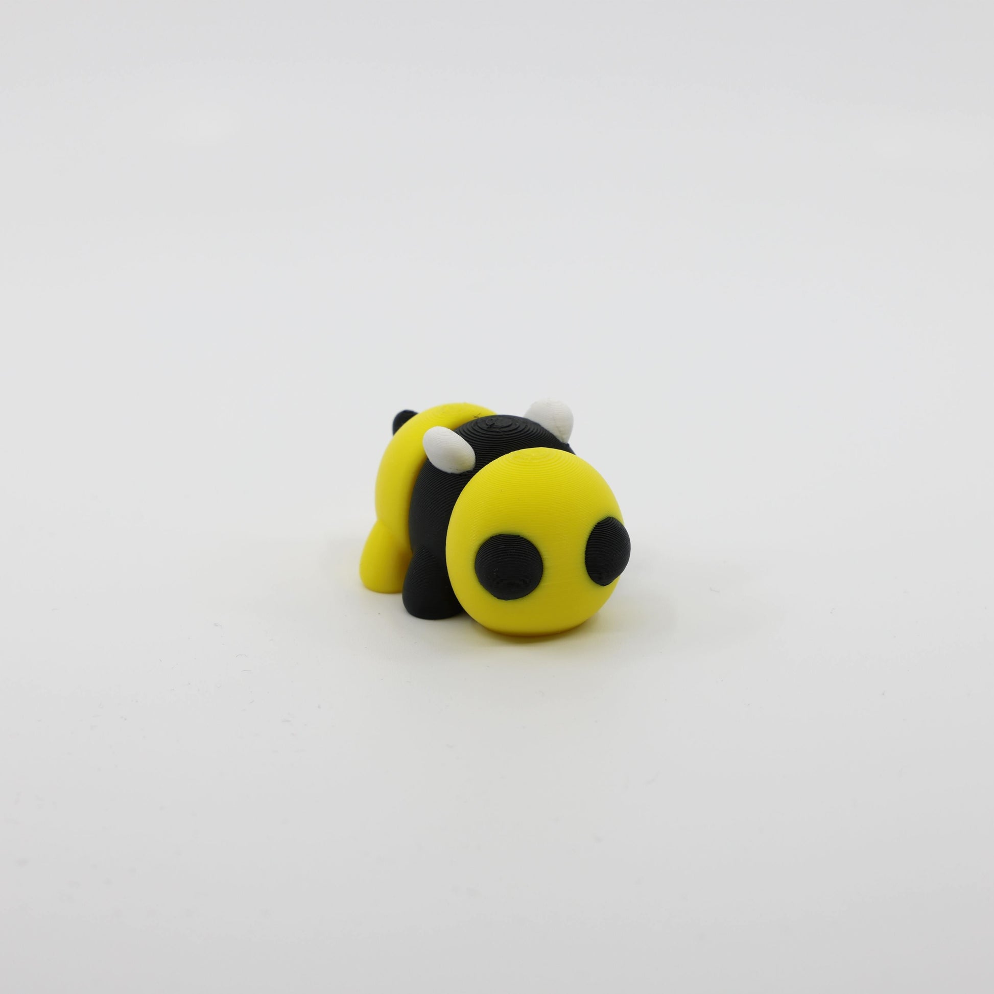 Front view of articulated mini bee sensory fidget with detailed wings and 3D printed facial features