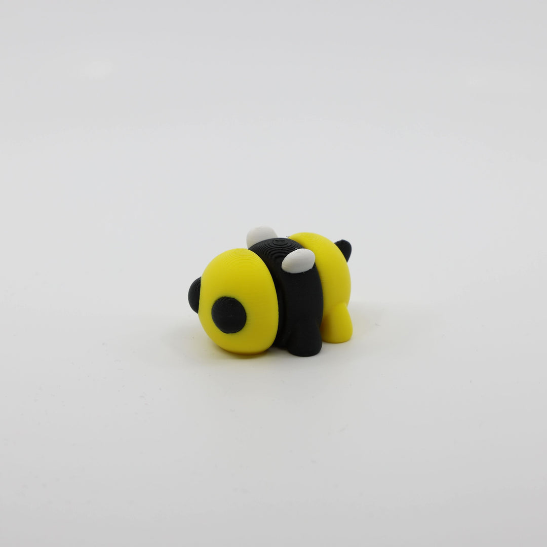 Side profile of articulated bee sensory fidget highlighting body segments and wings.