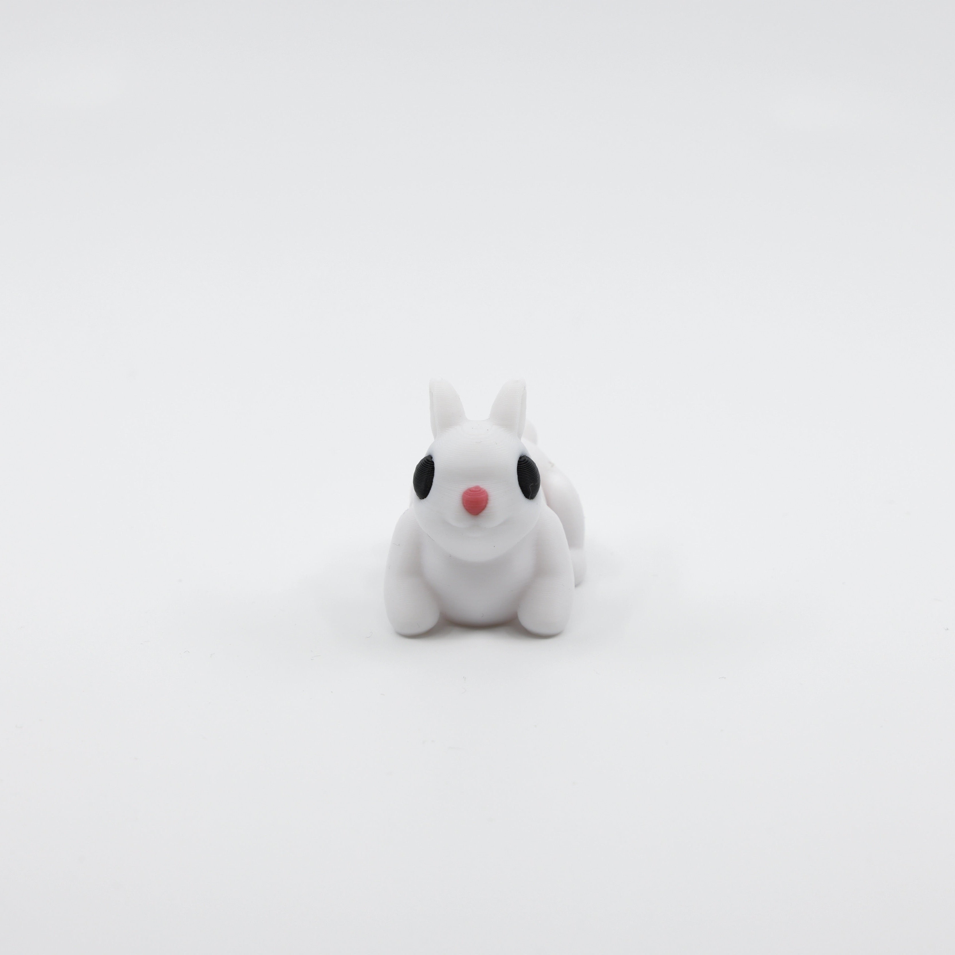 Front view of articulated mini bunny sensory fidget with cute facial features
