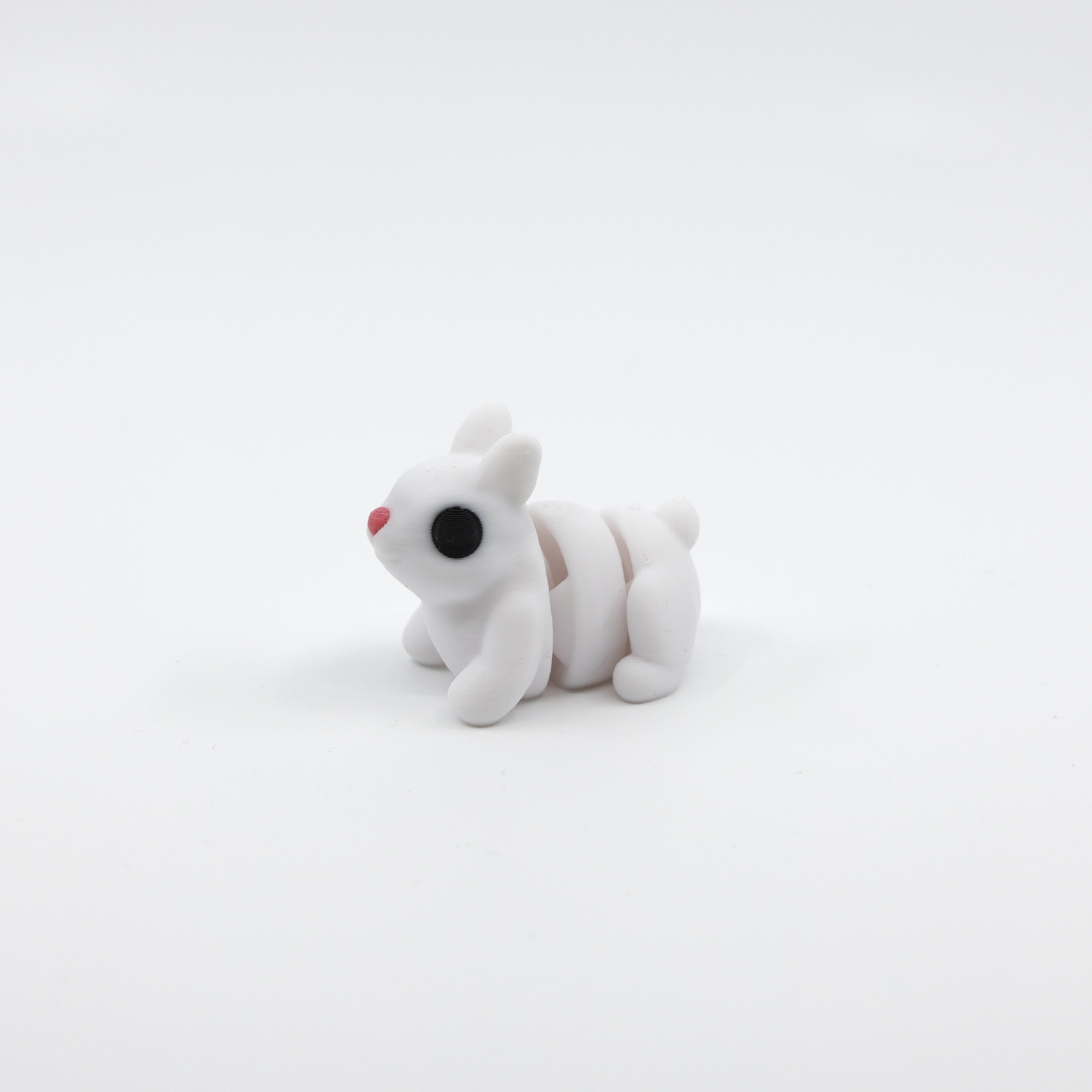 Side profile of articulated bunny sensory fidget with poseable body design