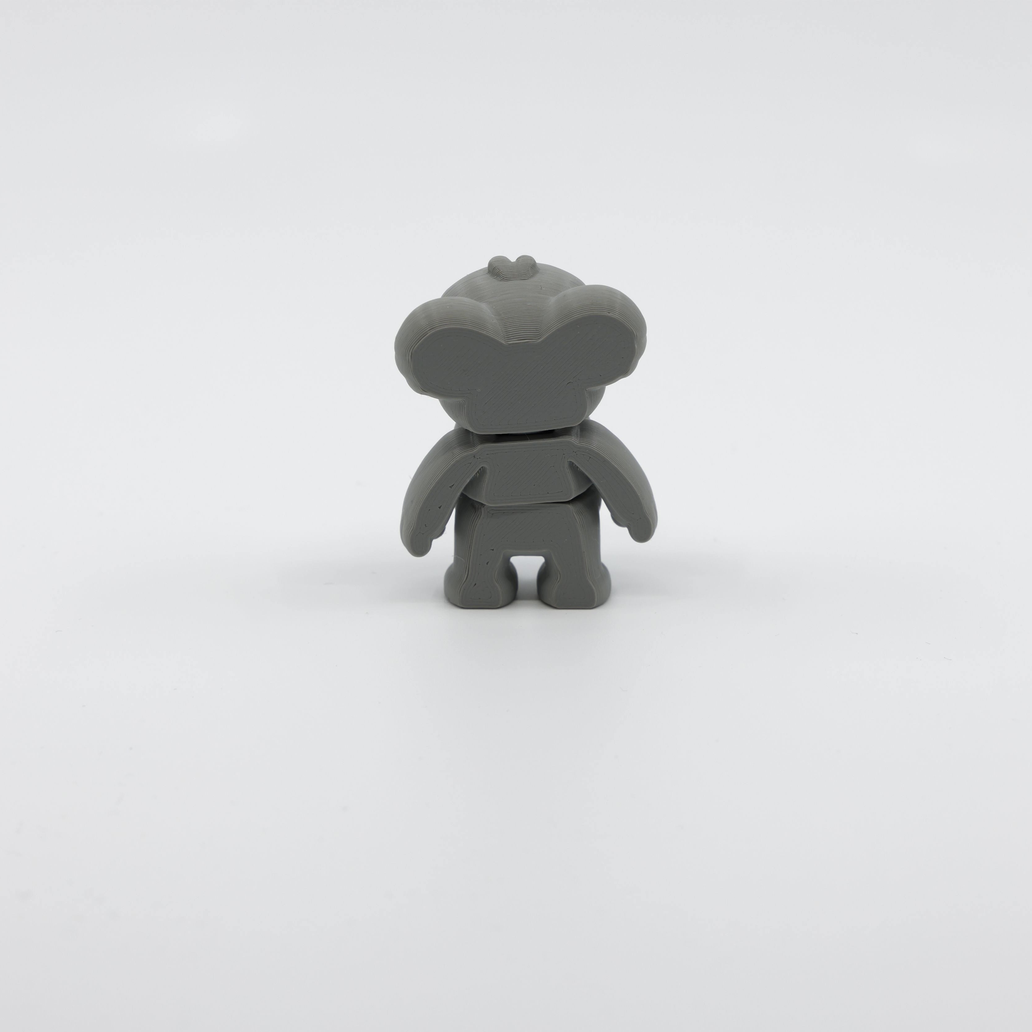 Back view of mini koala fidget showing segmented articulated body and fluffy tail