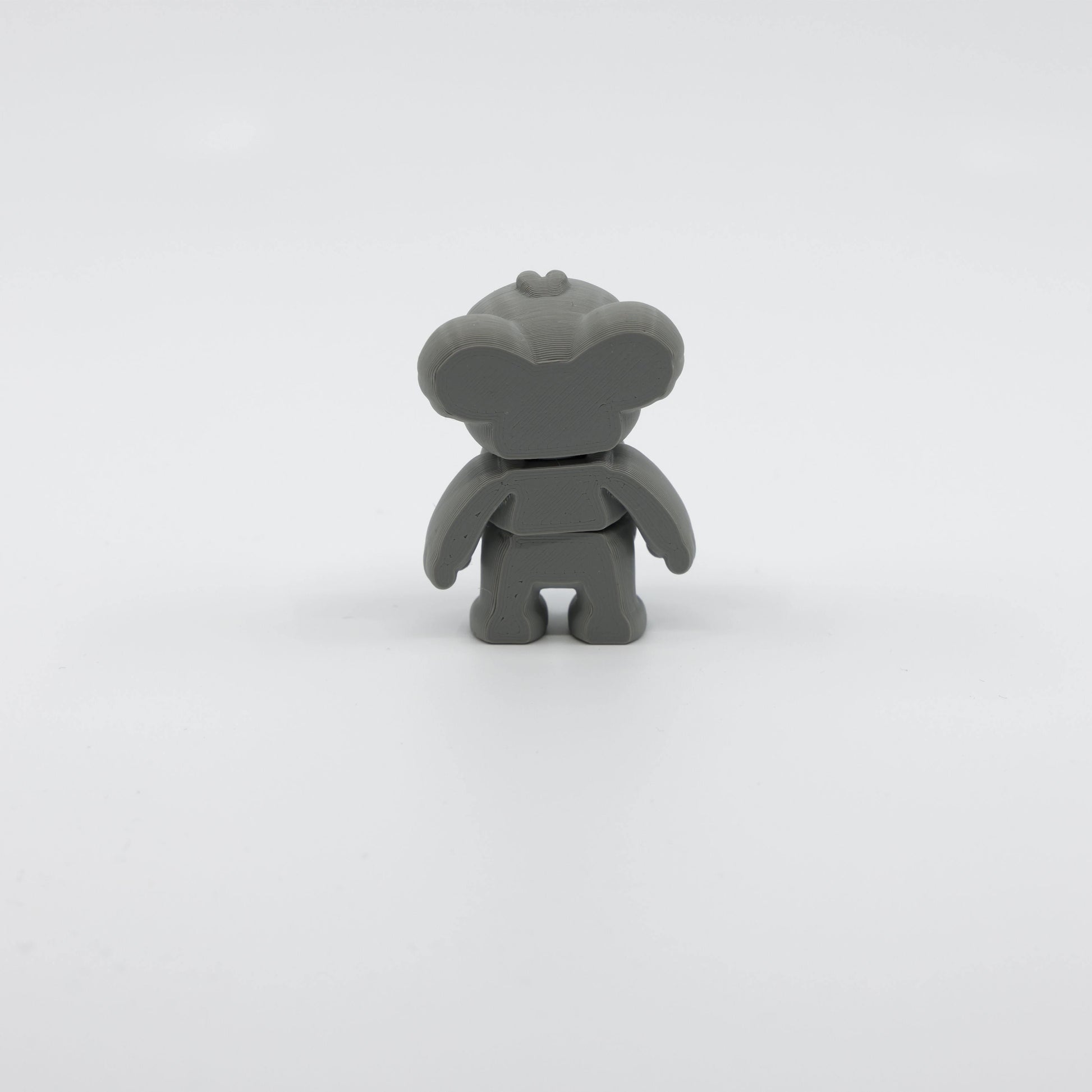 Back view of mini koala fidget showing segmented articulated body and fluffy tail