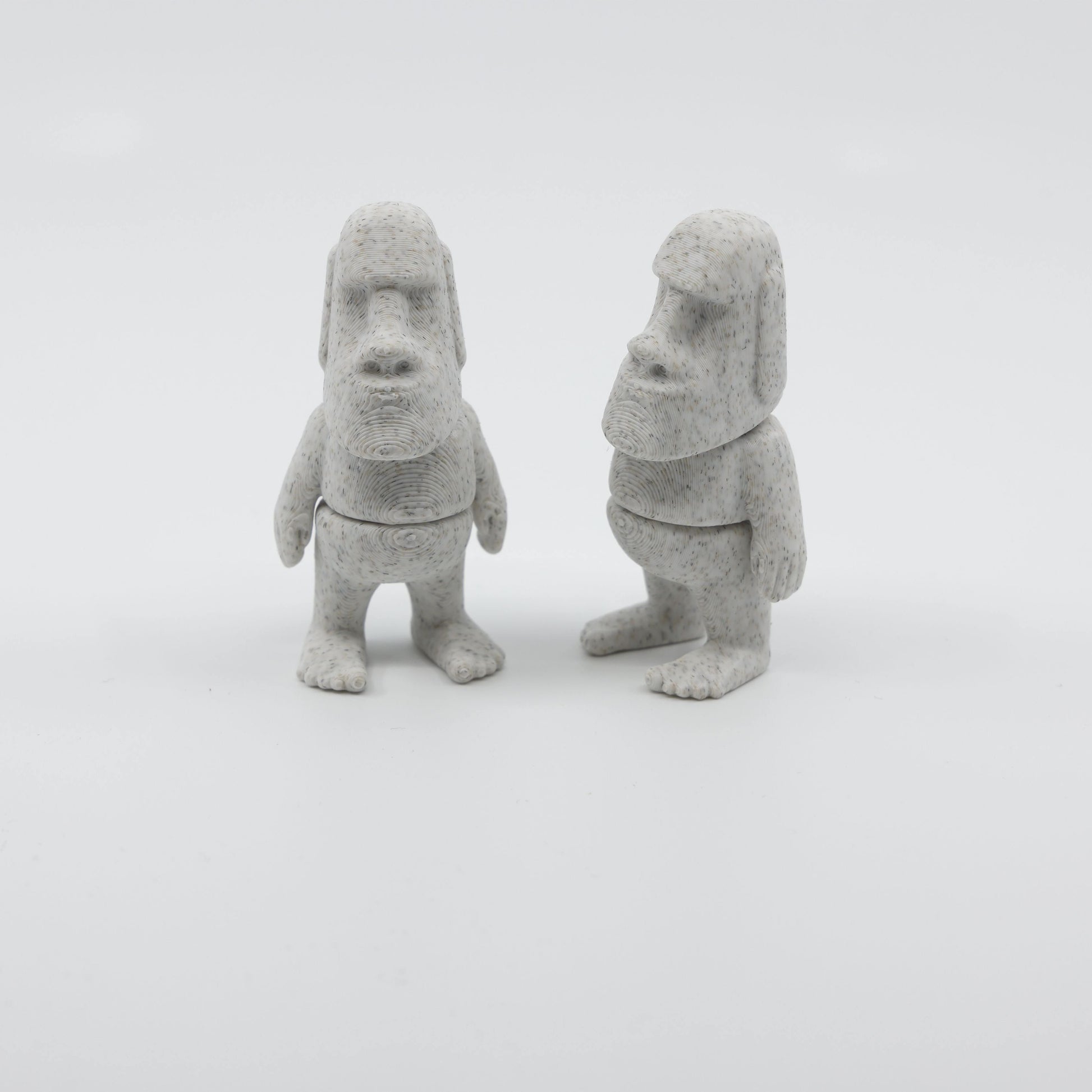 Two articulated mini Moai fidgets side by side, showcasing sensory-friendly design and intricate details