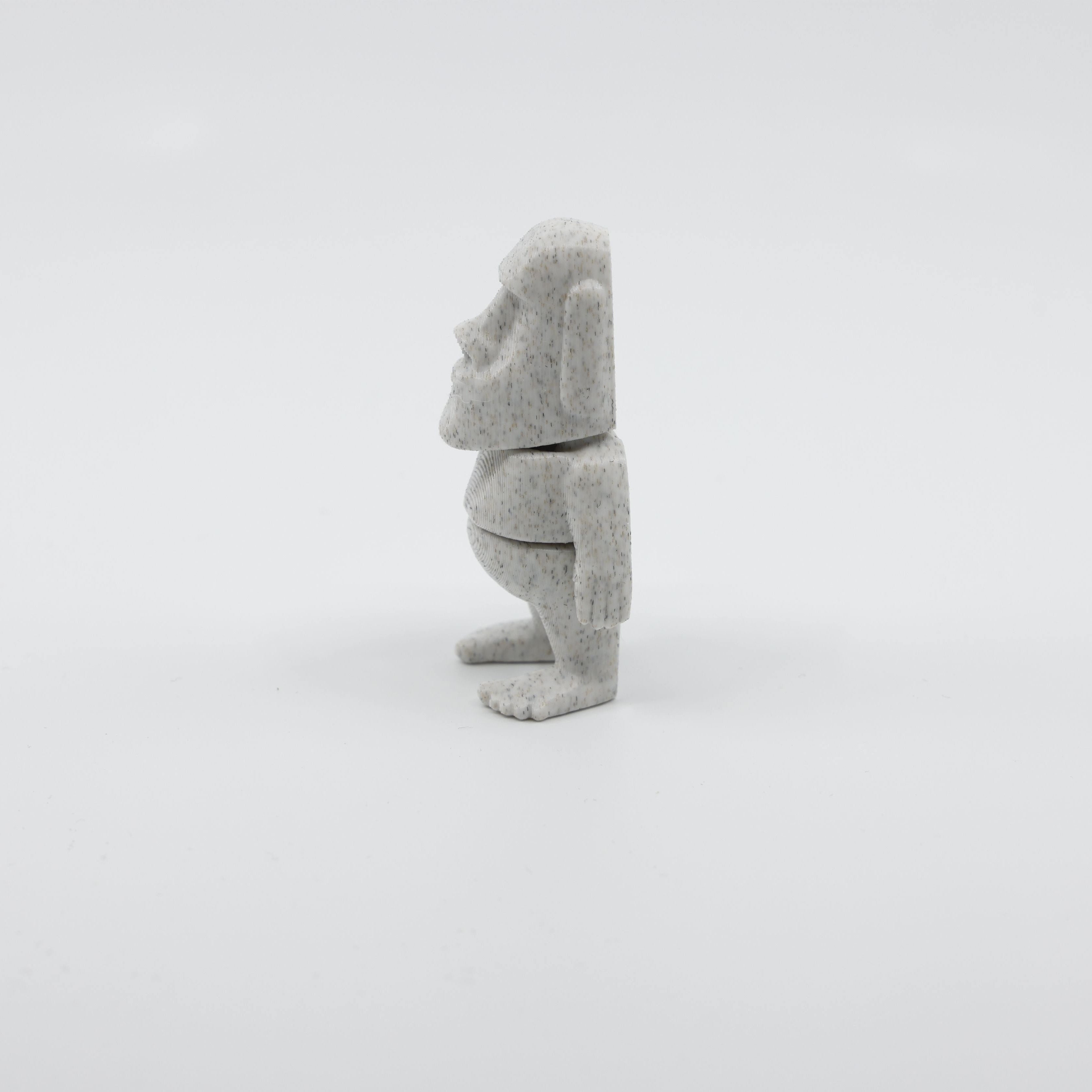 Side profile of articulated Moai sensory fidget highlighting smooth body segments and iconic face shape
