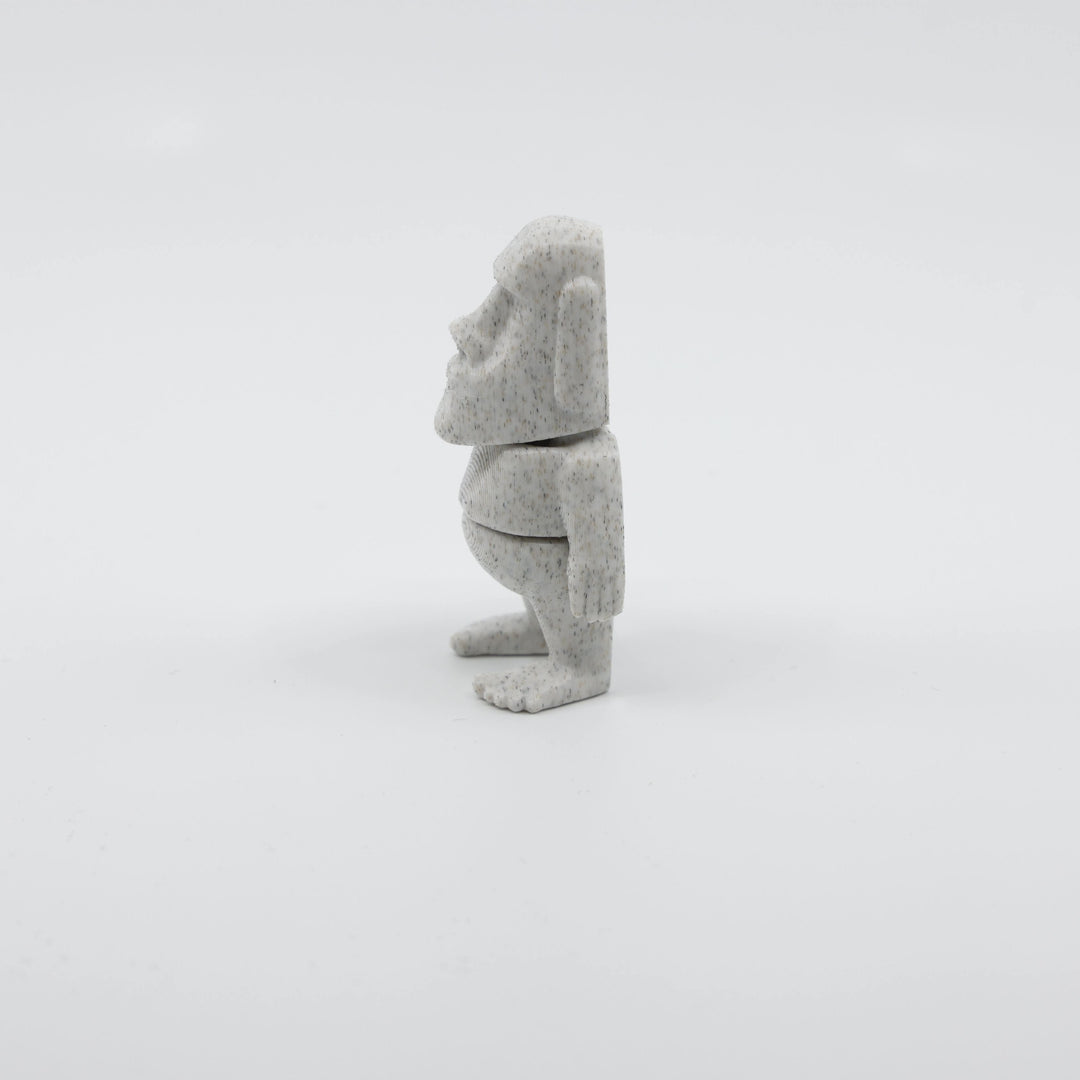 Side profile of articulated Moai sensory fidget highlighting smooth body segments and iconic face shape