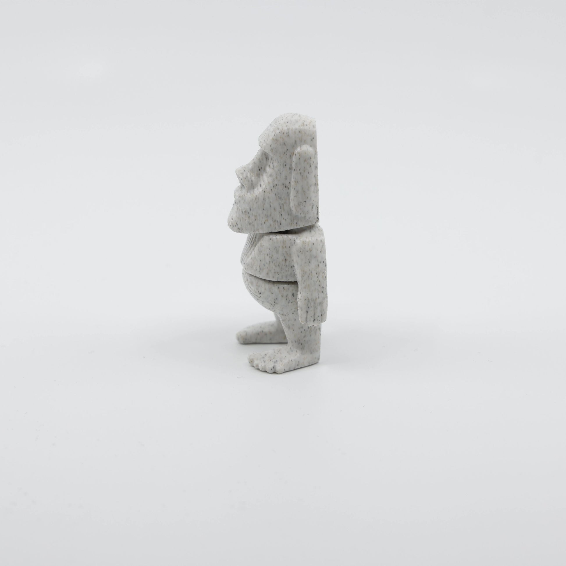 Side profile of articulated Moai sensory fidget highlighting smooth body segments and iconic face shape