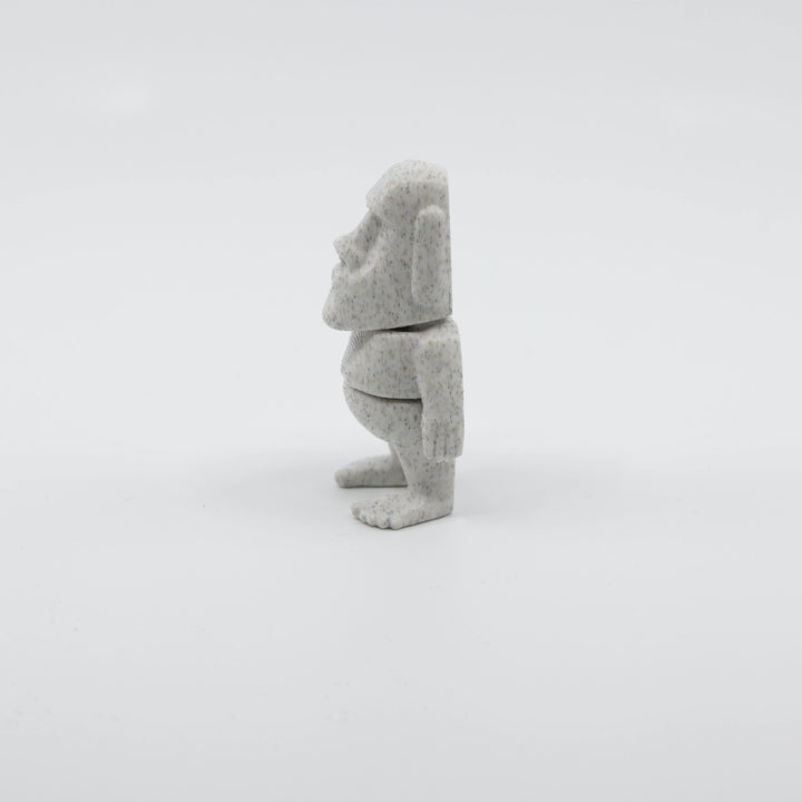 Side profile of articulated Moai sensory fidget highlighting smooth body segments and iconic face shape