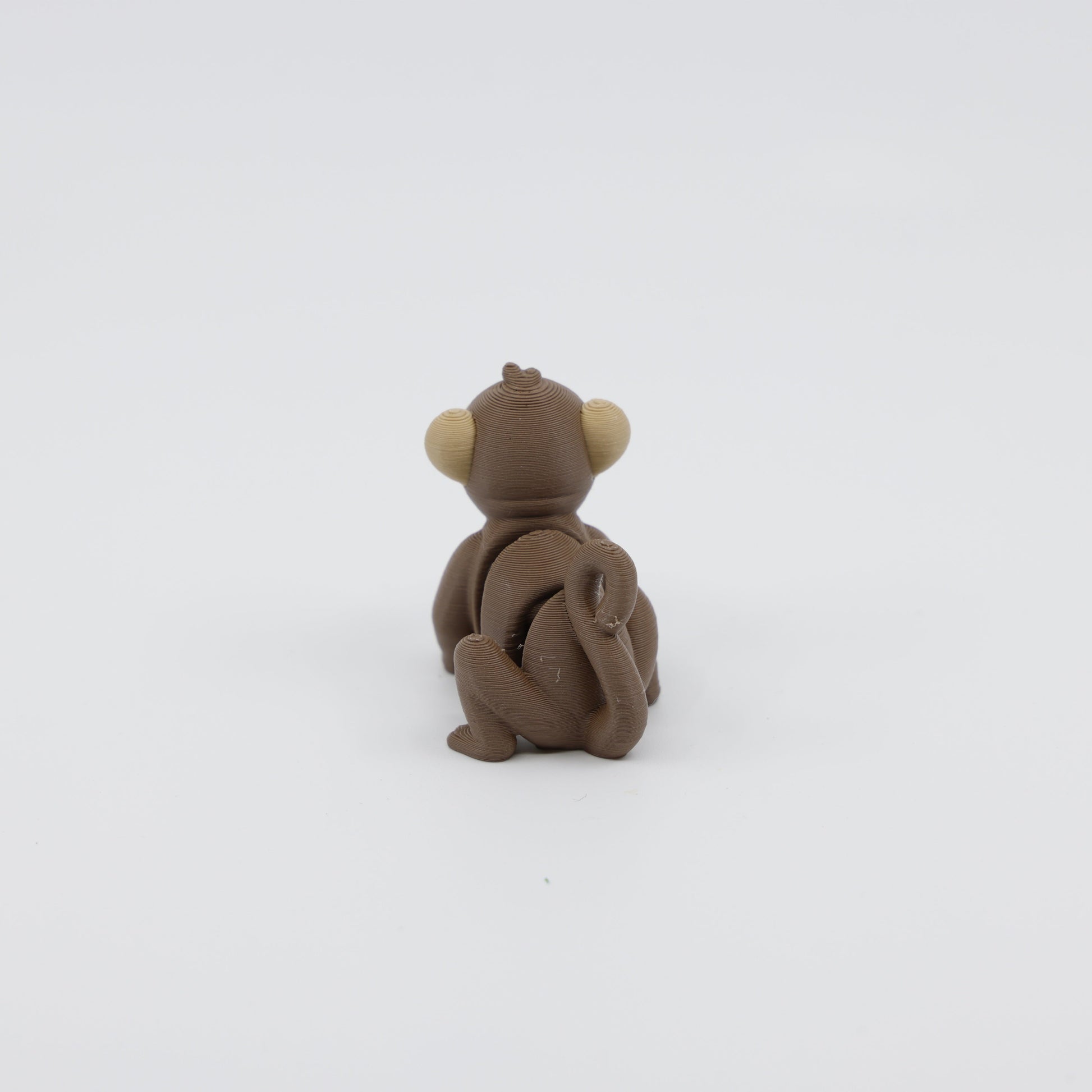Back view of 3D printed articulated monkey fidget showing sensory-friendly design and detailed tail