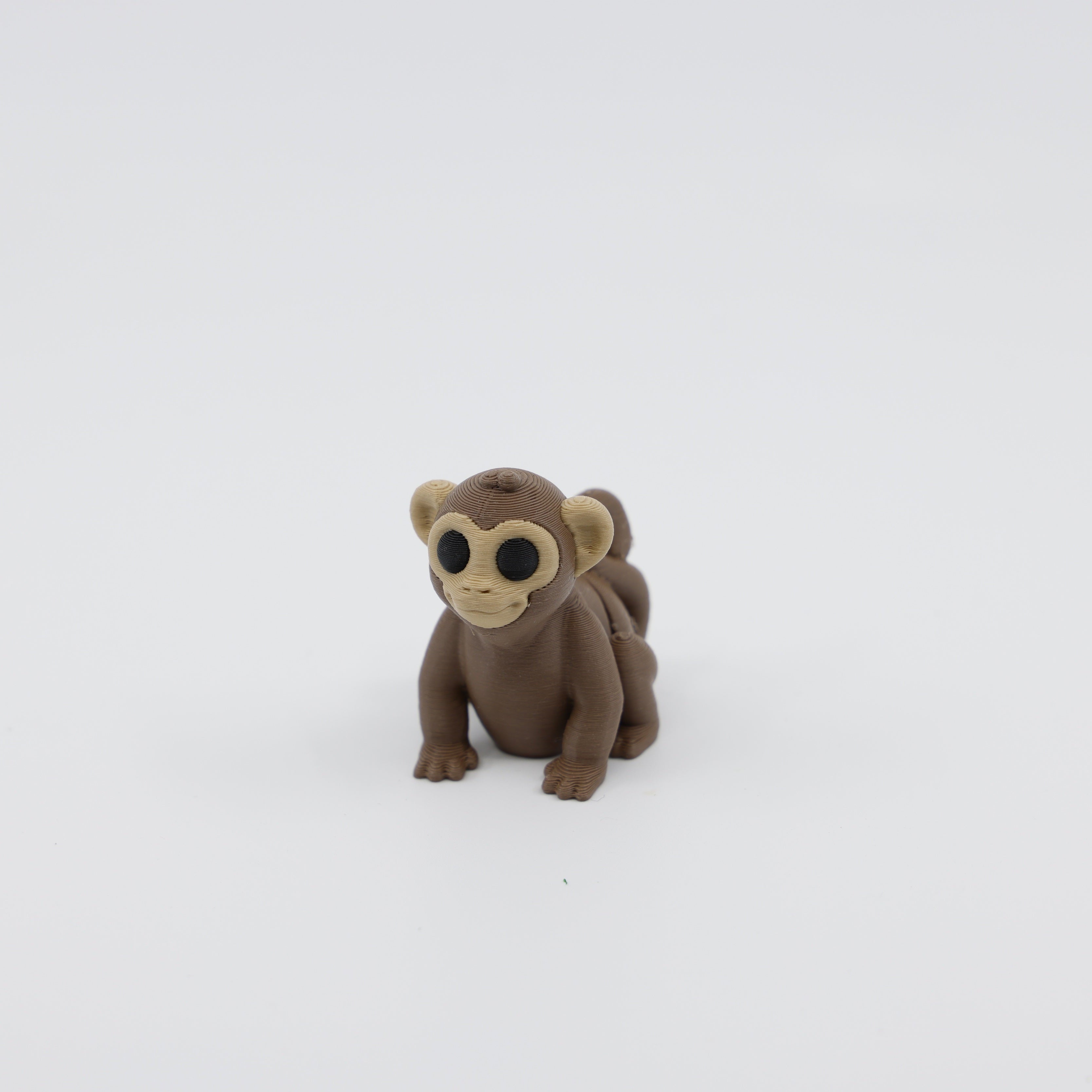 Front view of articulated mini monkey sensory fidget with flexible body segments