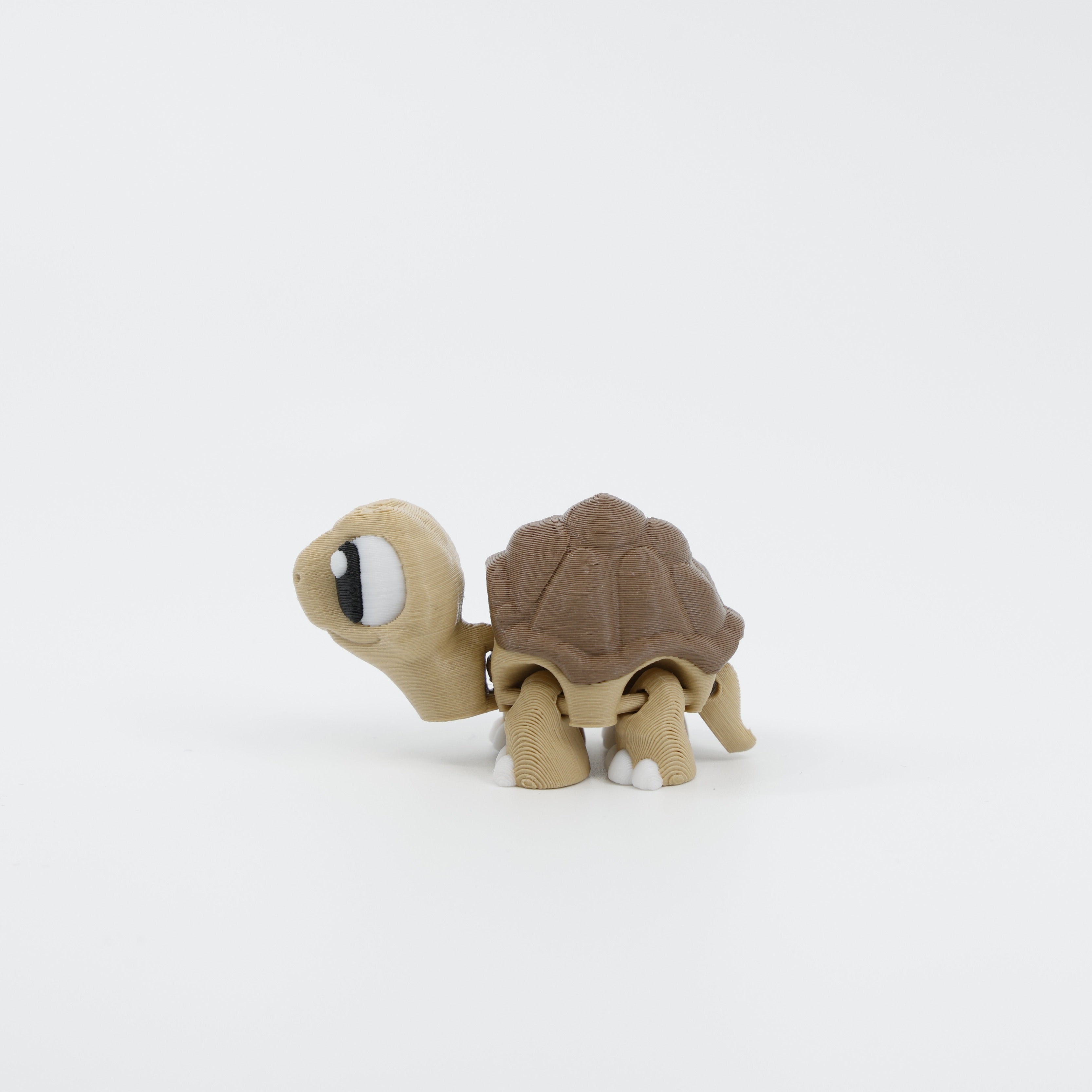 Side profile of mini tortoise sensory fidget with articulated body segments