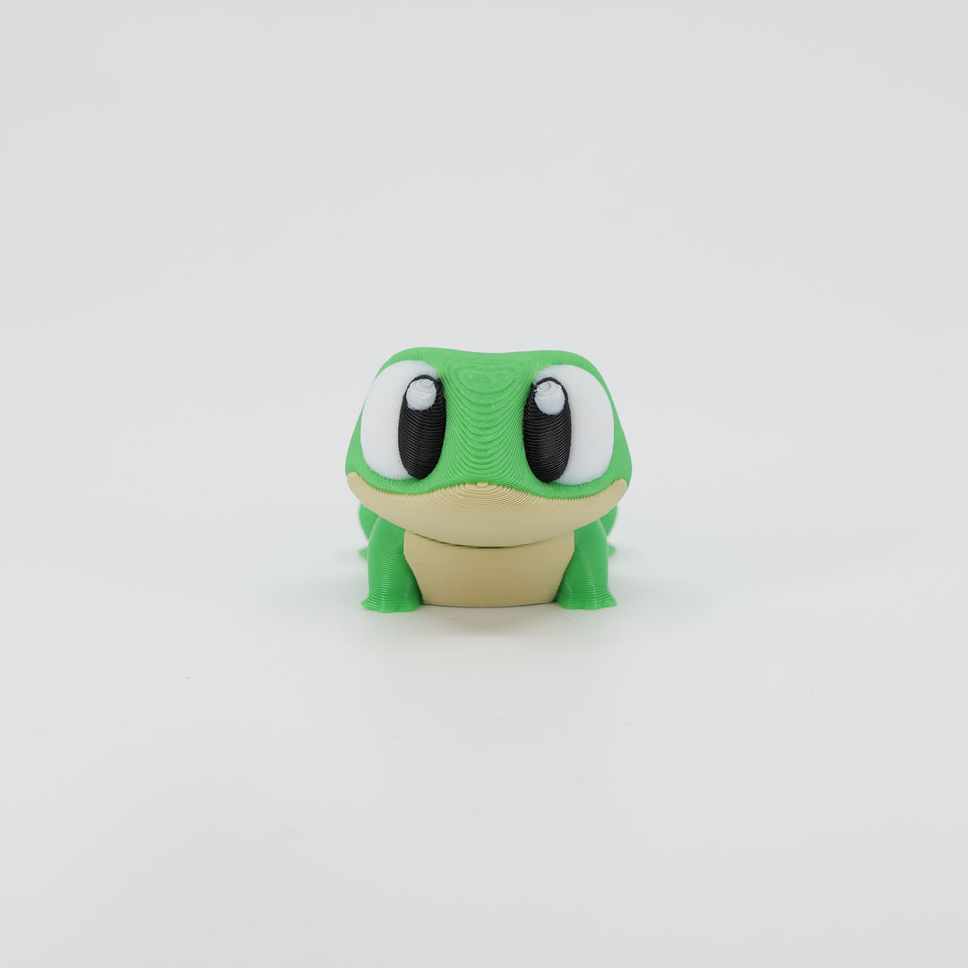 Front view of the Mini Frog Wiggle Bud fidget toy. Highlights the cute wide eyes and articulated front legs created via 3D printing.