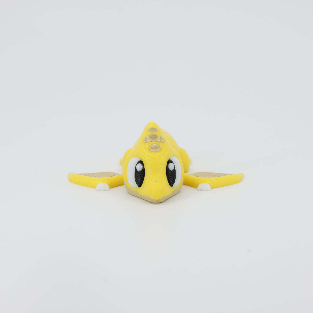 Front view of the Mini Pterodactyl Wiggle Bud fidget toy. Highlights the pointed beak and articulated wings created via 3D printing.