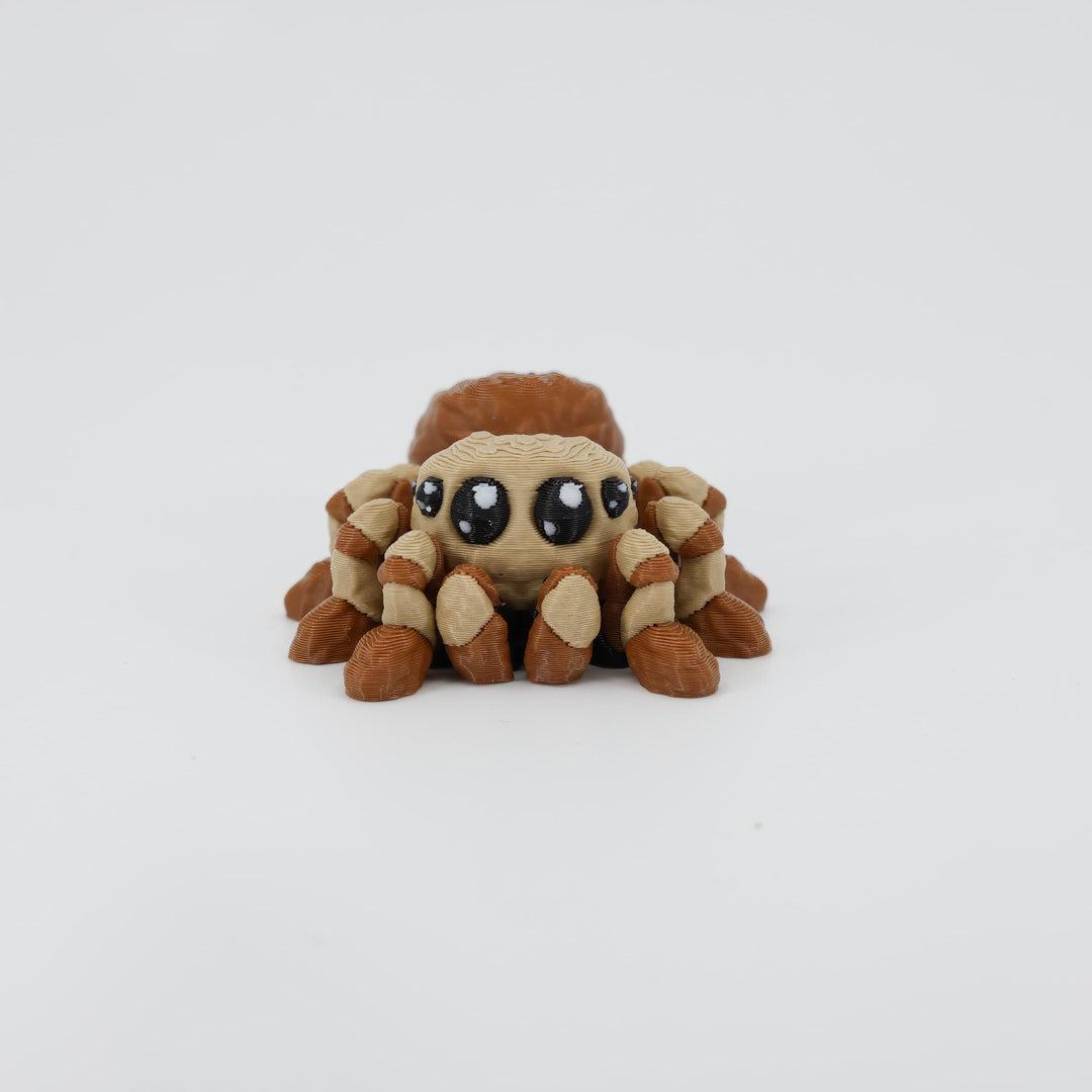 Front view of the Mini Spider Wiggle Bud fidget toy. Highlights the cute eyes and articulated front legs created via 3D printing.