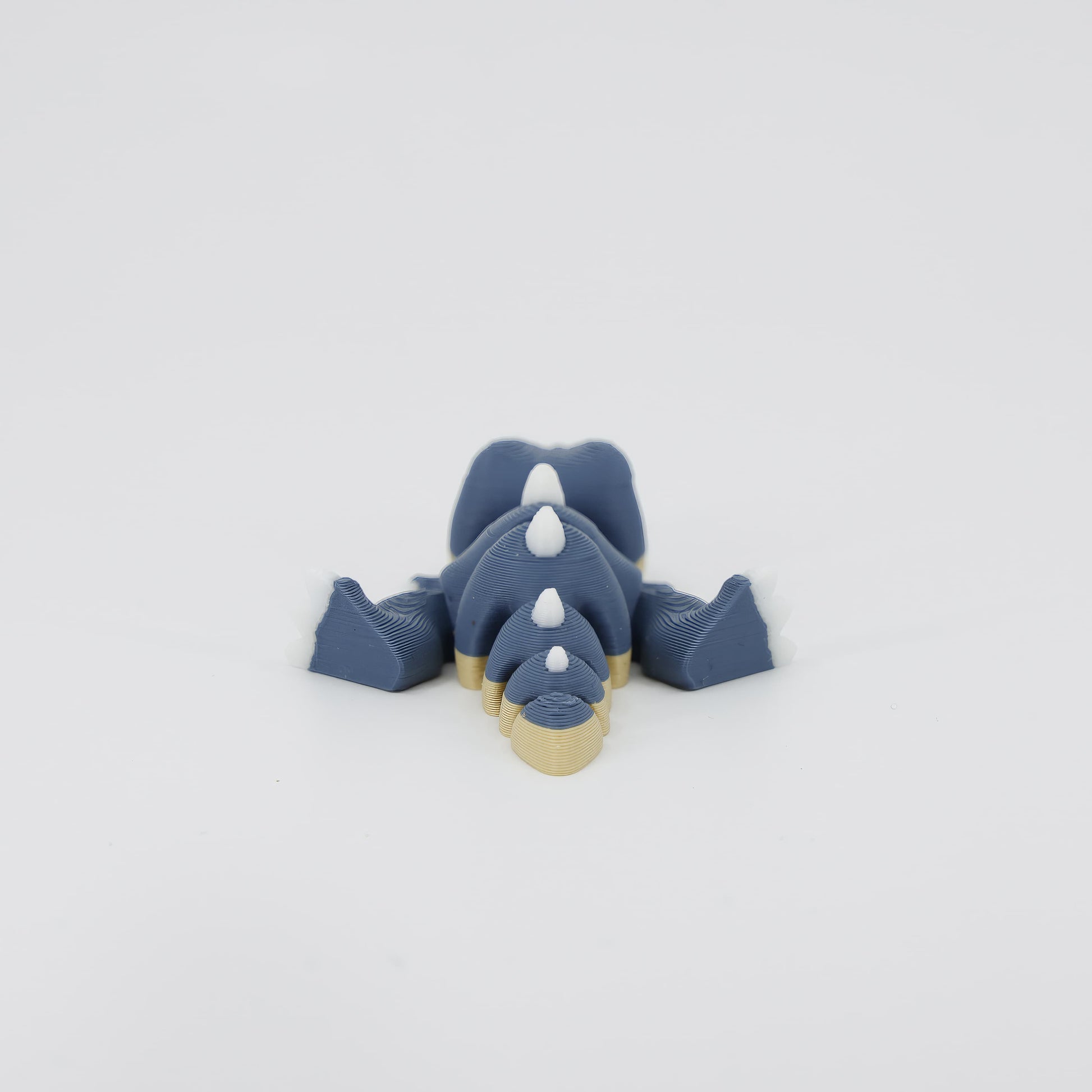 Back view of the miniature 3D printed T-Rex Wiggle Bud. Highlights the interlocking design of the segments crucial for the toy's wiggle action.