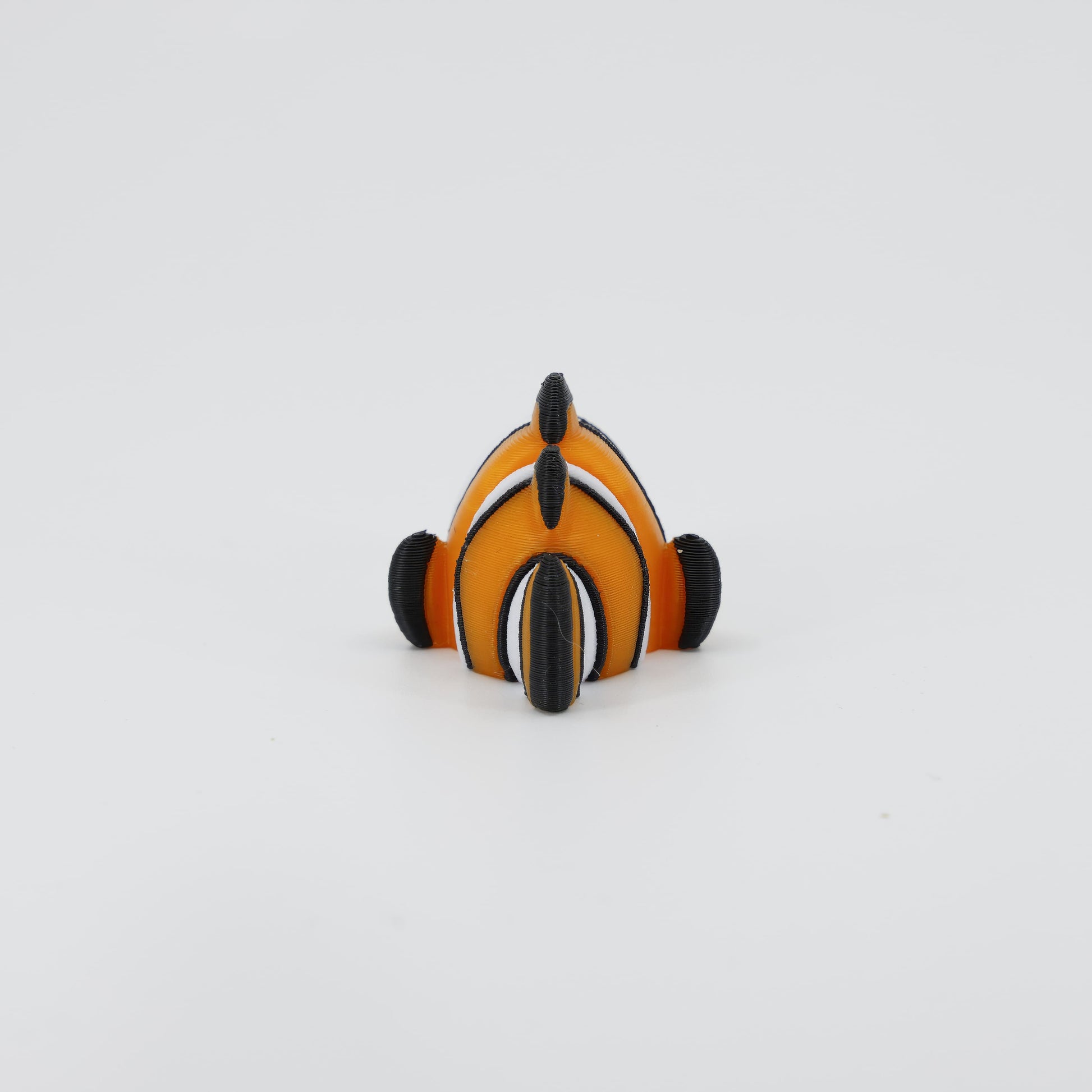 Back detail of the sensory 3D printed Clownfish toy, clearly showing the segmented tail designed for full wiggle action.