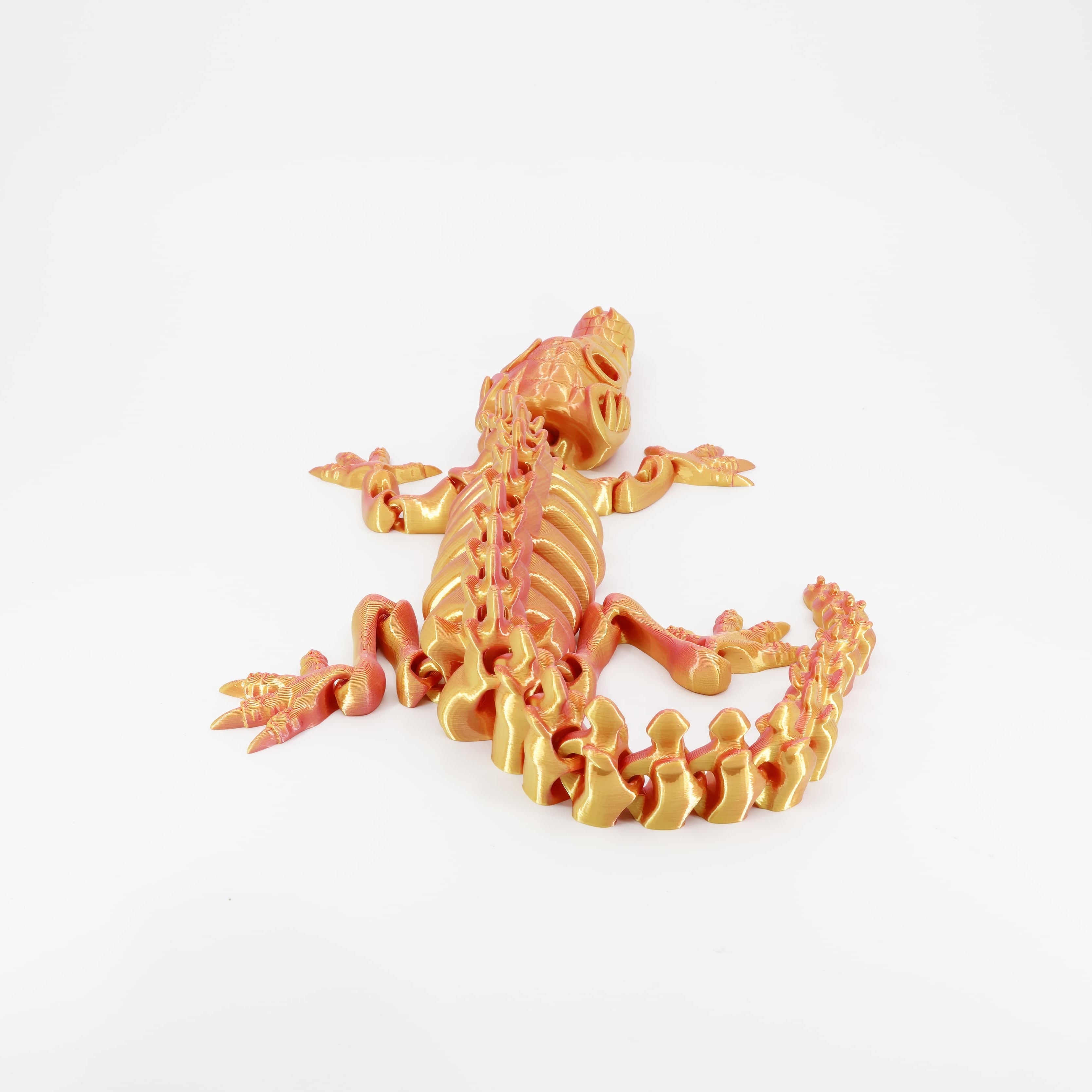 Back detail of the sensory 3D printed crocodile skeleton, clearly showing the long segmented tail designed for full fidget action.